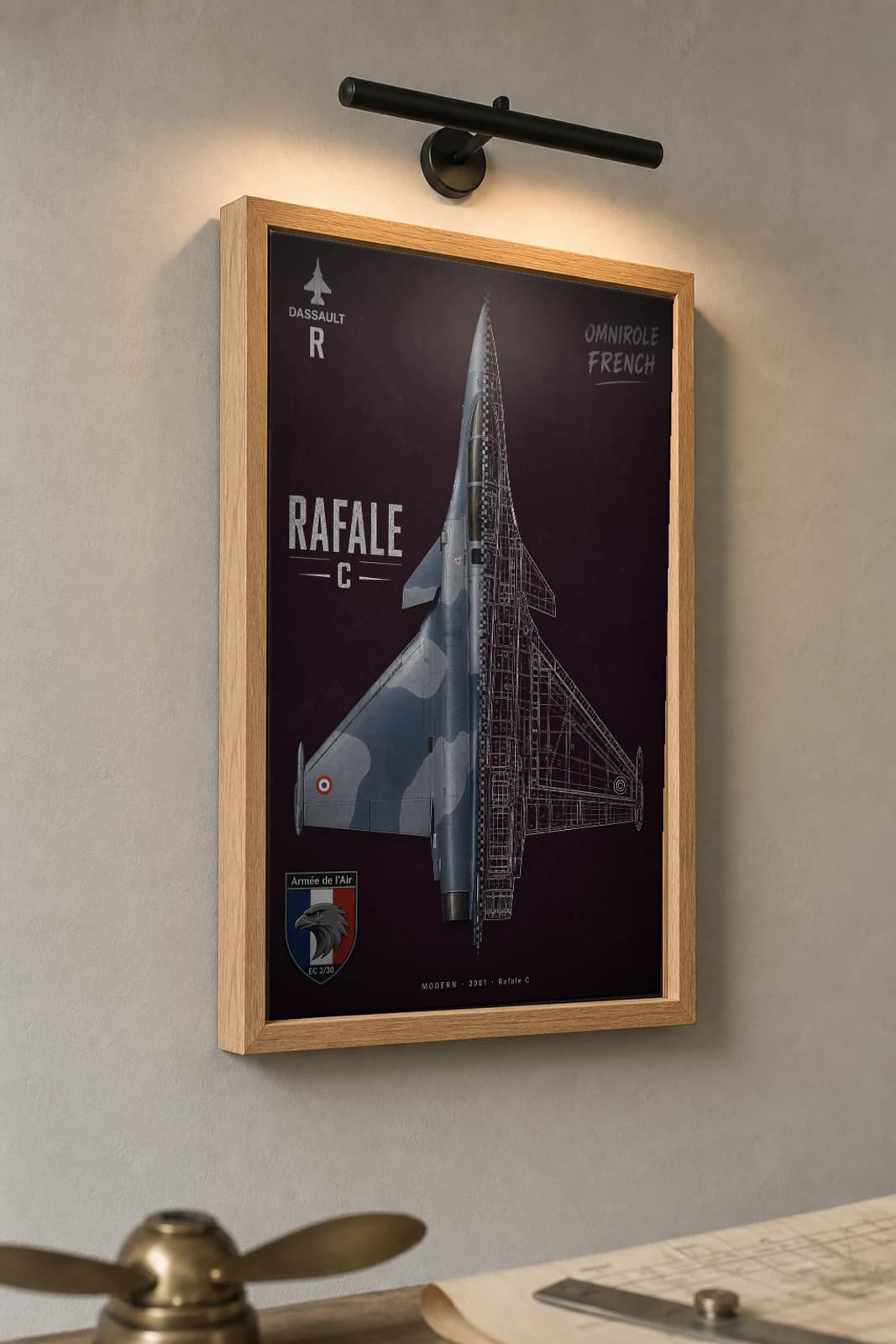 Dassault Rafale Cutaway Poster — Rafale C Modern Split-View Blueprint Print — the framed print shown at a three-quarter angle on a styled gallery wall in a natural-oak frame