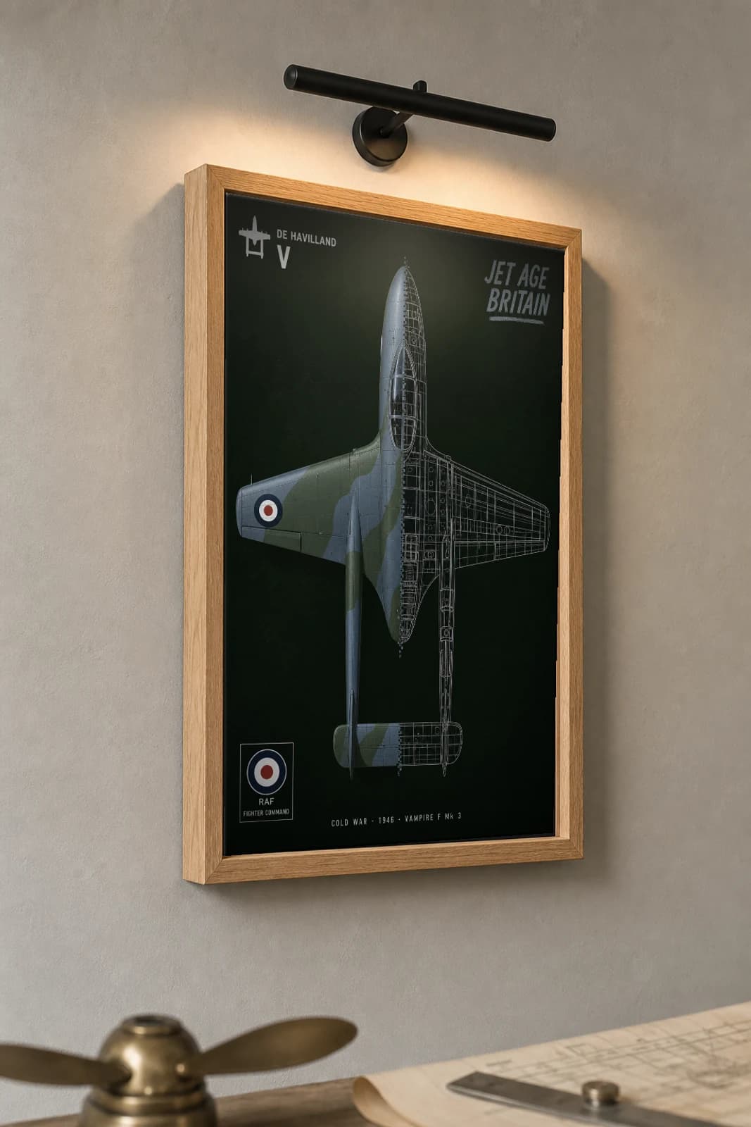 de Havilland Vampire Cutaway Poster — F Mk 3 Cold War Split-View Blueprint Print — the framed print shown at a three-quarter angle on a styled gallery wall in a natural-oak frame