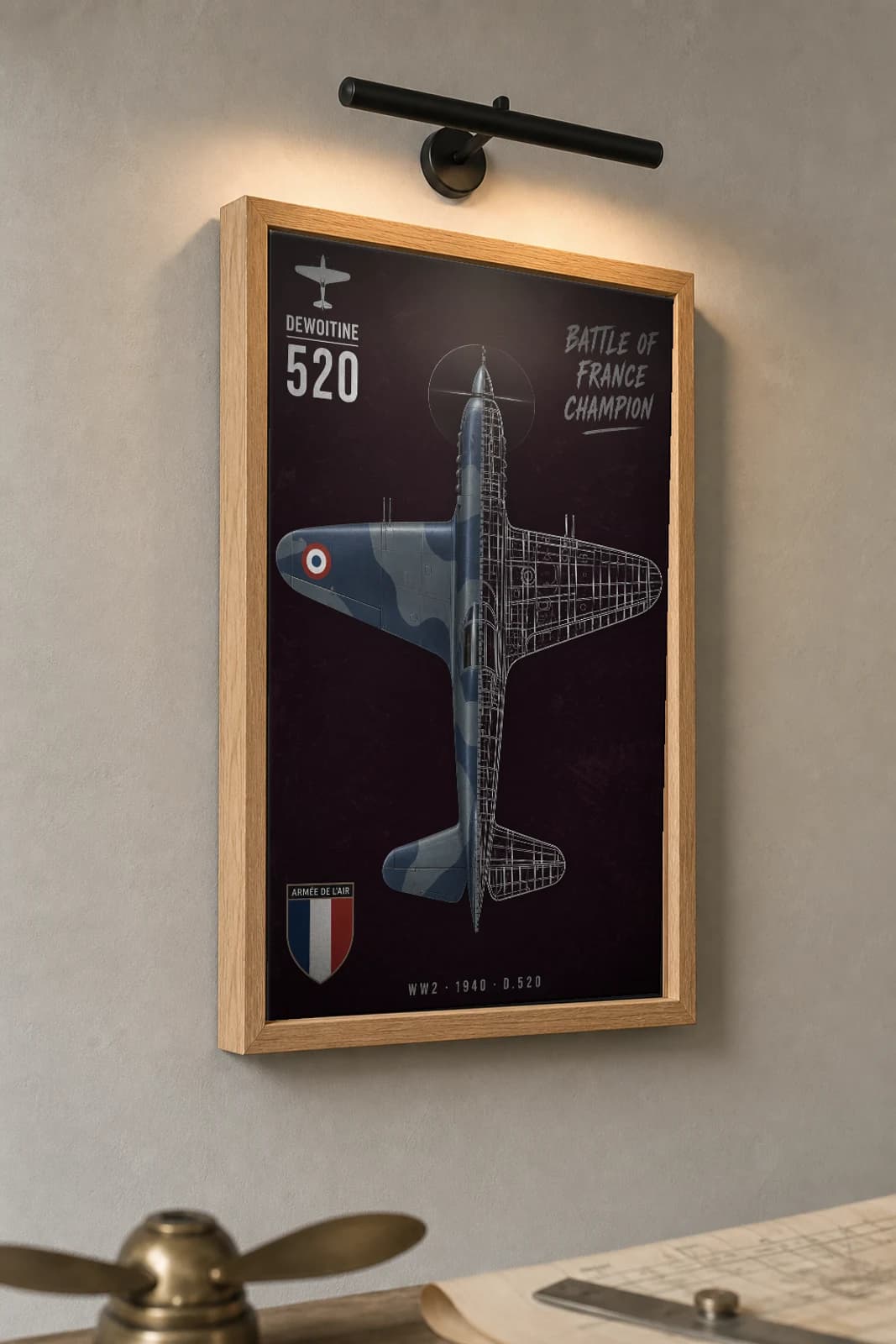 Dewoitine D.520 Cutaway Poster — D.520 WW2 Split-View Blueprint Print — the framed print shown at a three-quarter angle on a styled gallery wall in a natural-oak frame