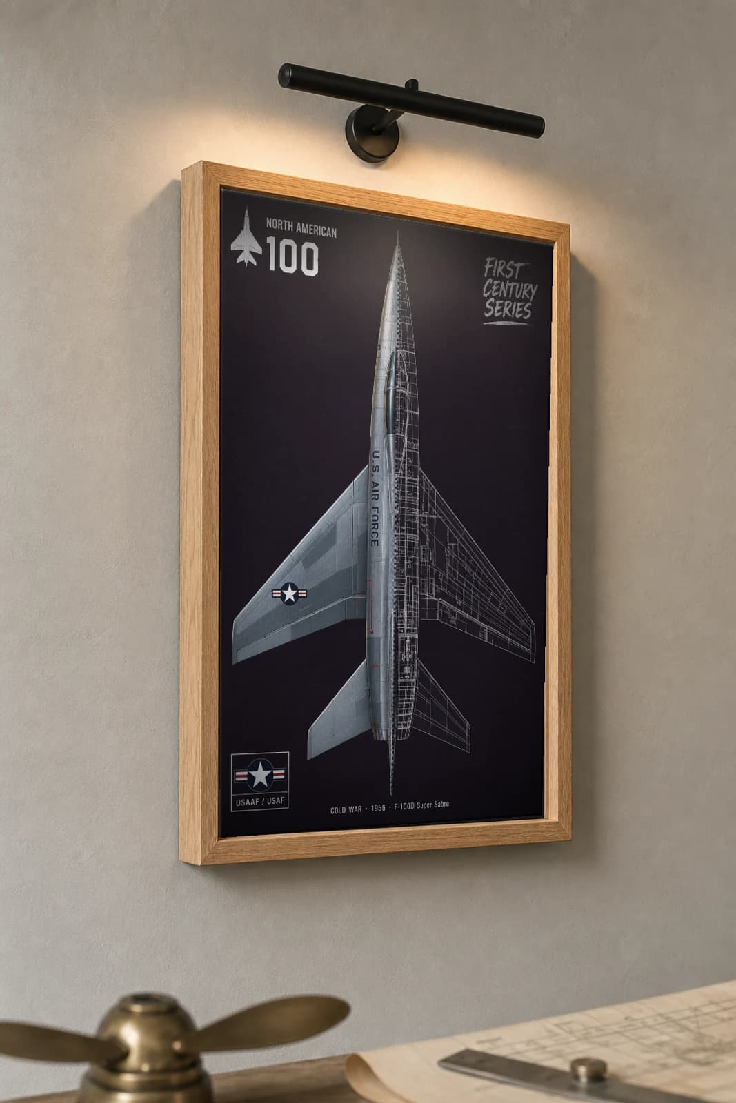 F-100 Super Sabre Cutaway Poster — F-100D Cold War Split-View Blueprint Print — the framed print shown at a three-quarter angle on a styled gallery wall in a natural-oak frame