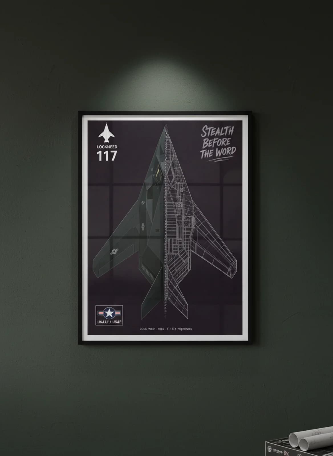 F-117A Nighthawk cutaway poster in black A2 frame on matte-black-facets deep forest wall — Aircraft Cutaways enthusiast study mockup