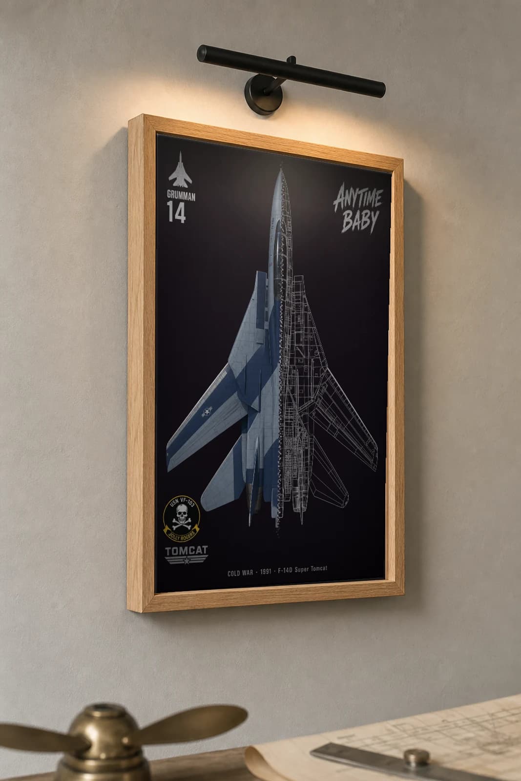 F-14D Super Tomcat Cutaway Poster — F-14D Super Tomcat Cold War Split-View Blueprint Print — the framed print shown at a three-quarter angle on a styled gallery wall in a natural-oak frame