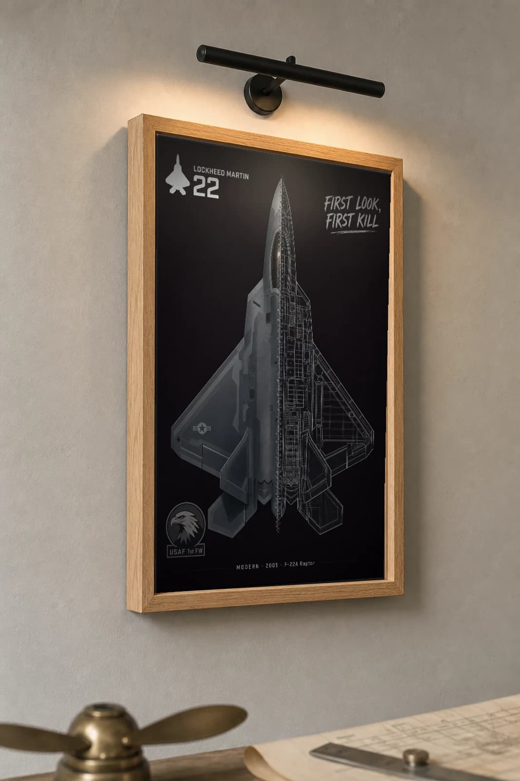 F-22 Raptor Cutaway Poster — F-22A Modern Split-View Blueprint Print — the framed print shown at a three-quarter angle on a styled gallery wall in a natural-oak frame