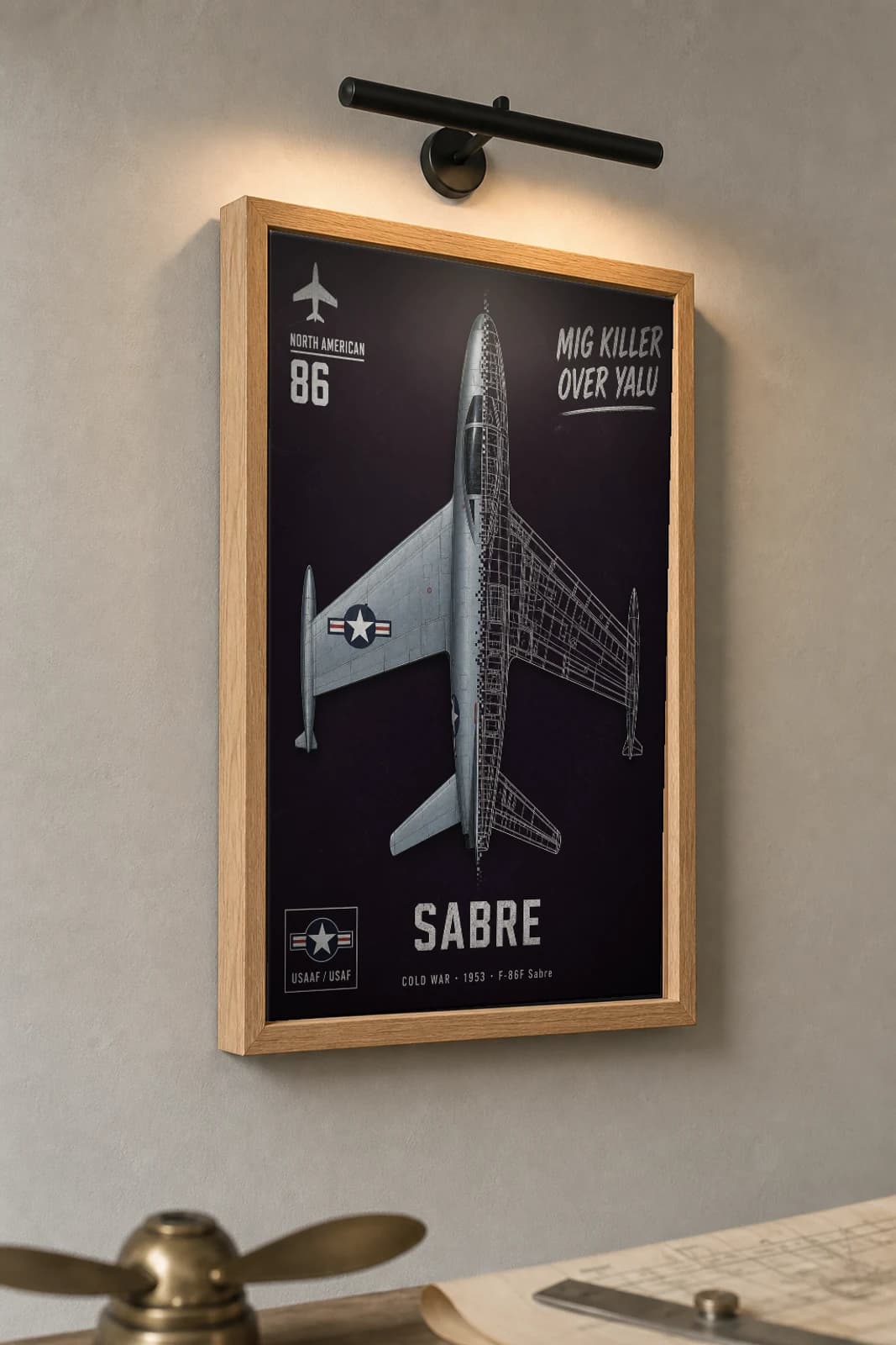 F-86 Sabre Cutaway Poster — F-86F Cold War Split-View Blueprint Print — the framed print shown at a three-quarter angle on a styled gallery wall in a natural-oak frame