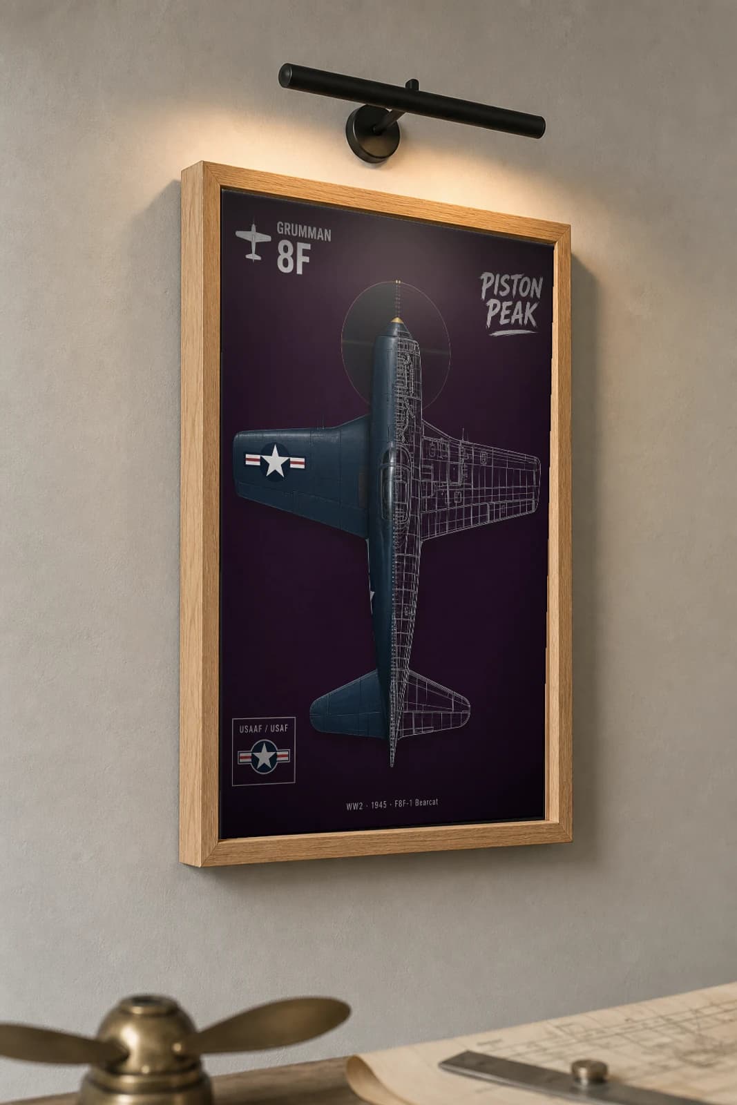 Grumman F8F Bearcat Cutaway Poster — F8F-1 WW2 Split-View Blueprint Print — the framed print shown at a three-quarter angle on a styled gallery wall in a natural-oak frame