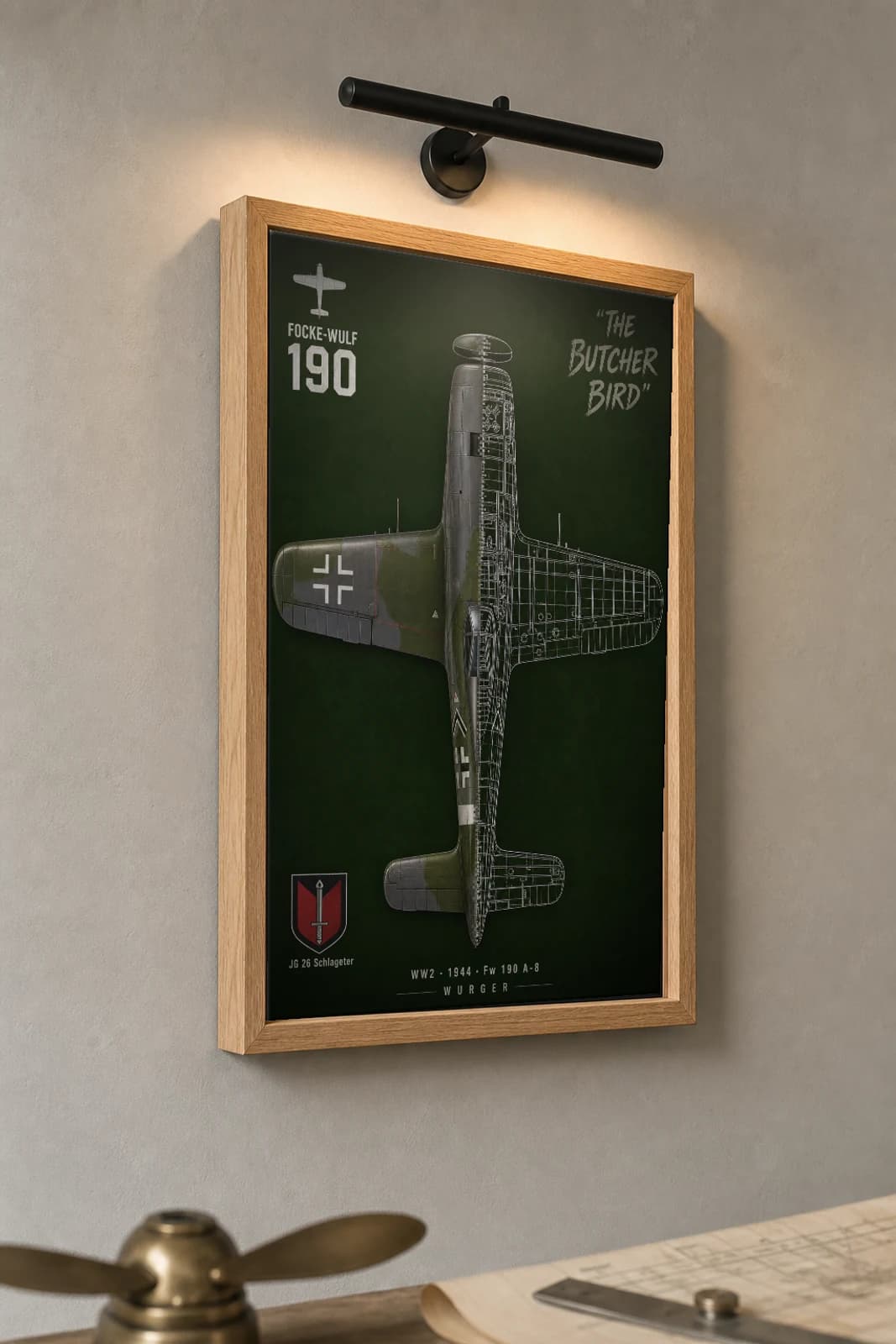 Focke-Wulf 190 Cutaway Poster — A-8 WW2 Split-View Blueprint Print — the framed print shown at a three-quarter angle on a styled gallery wall in a natural-oak frame
