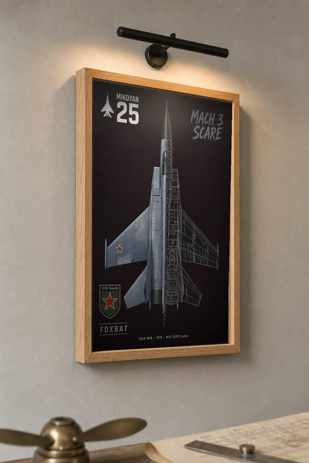 MiG-25 Cutaway Poster — MiG-25PD Foxbat Cold War Split-View Blueprint Print — the framed print shown at a three-quarter angle on a styled gallery wall in a natural-oak frame