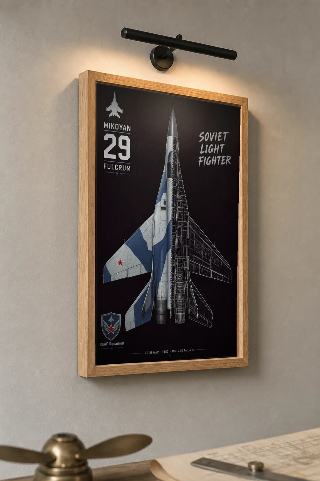 MiG-29S Fulcrum Cutaway Poster — MiG-29S Cold War Split-View Blueprint Print — the framed print shown at a three-quarter angle on a styled gallery wall in a natural-oak frame