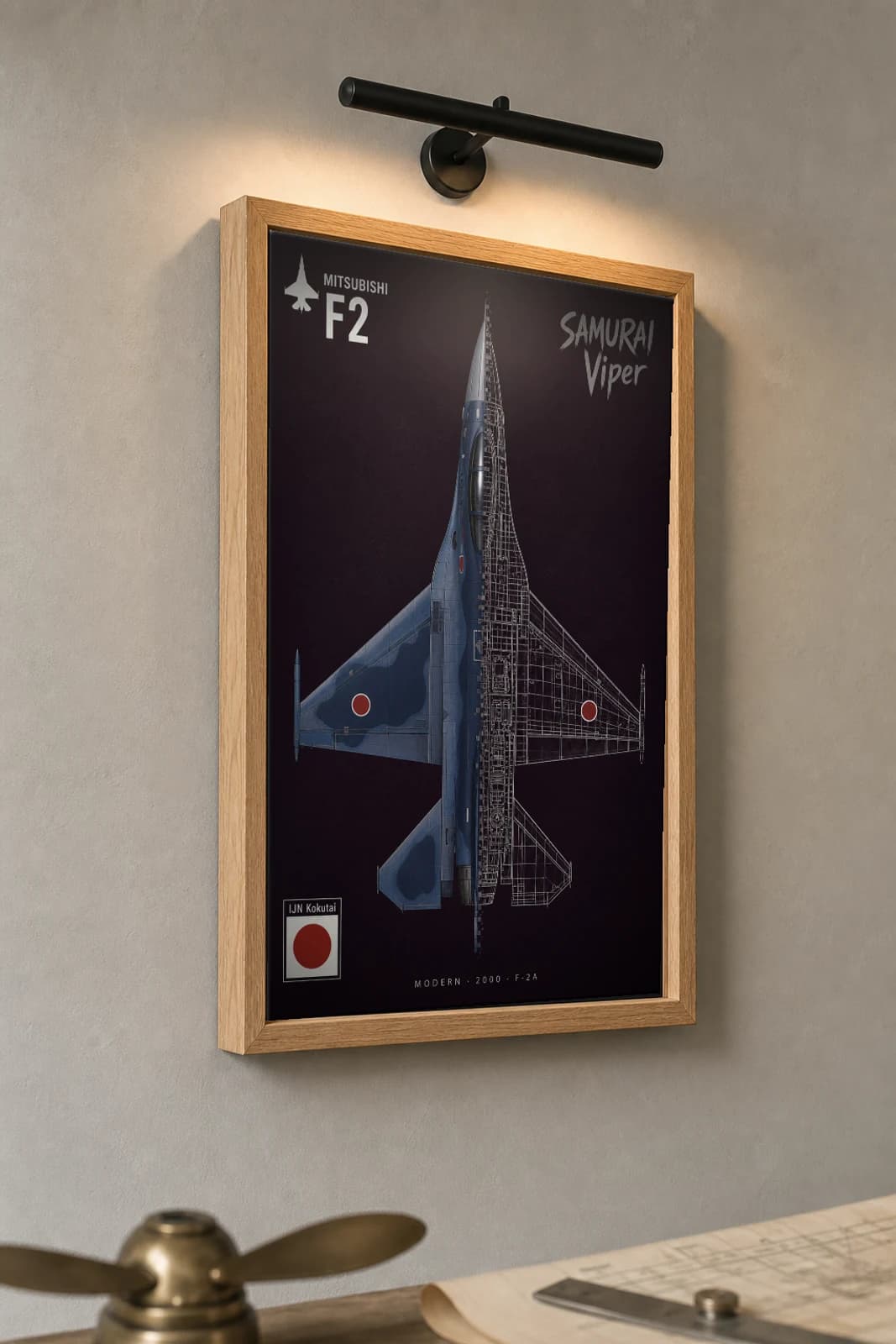Mitsubishi F-2 Cutaway Poster — F-2A Modern Split-View Blueprint Print — the framed print shown at a three-quarter angle on a styled gallery wall in a natural-oak frame