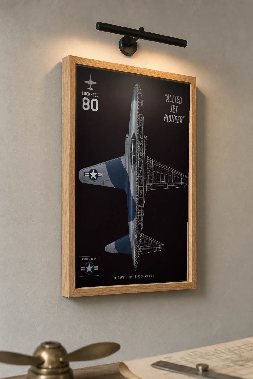 P-80 Shooting Star Cutaway Poster — P-80 Cold War Split-View Blueprint Print — the framed print shown at a three-quarter angle on a styled gallery wall in a natural-oak frame