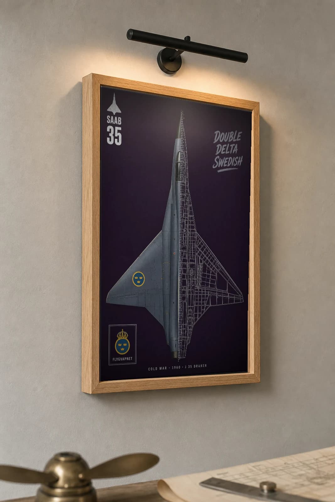 Saab J 35 Draken Cutaway Poster — J 35 Draken Cold War Split-View Blueprint Print — the framed print shown at a three-quarter angle on a styled gallery wall in a natural-oak frame