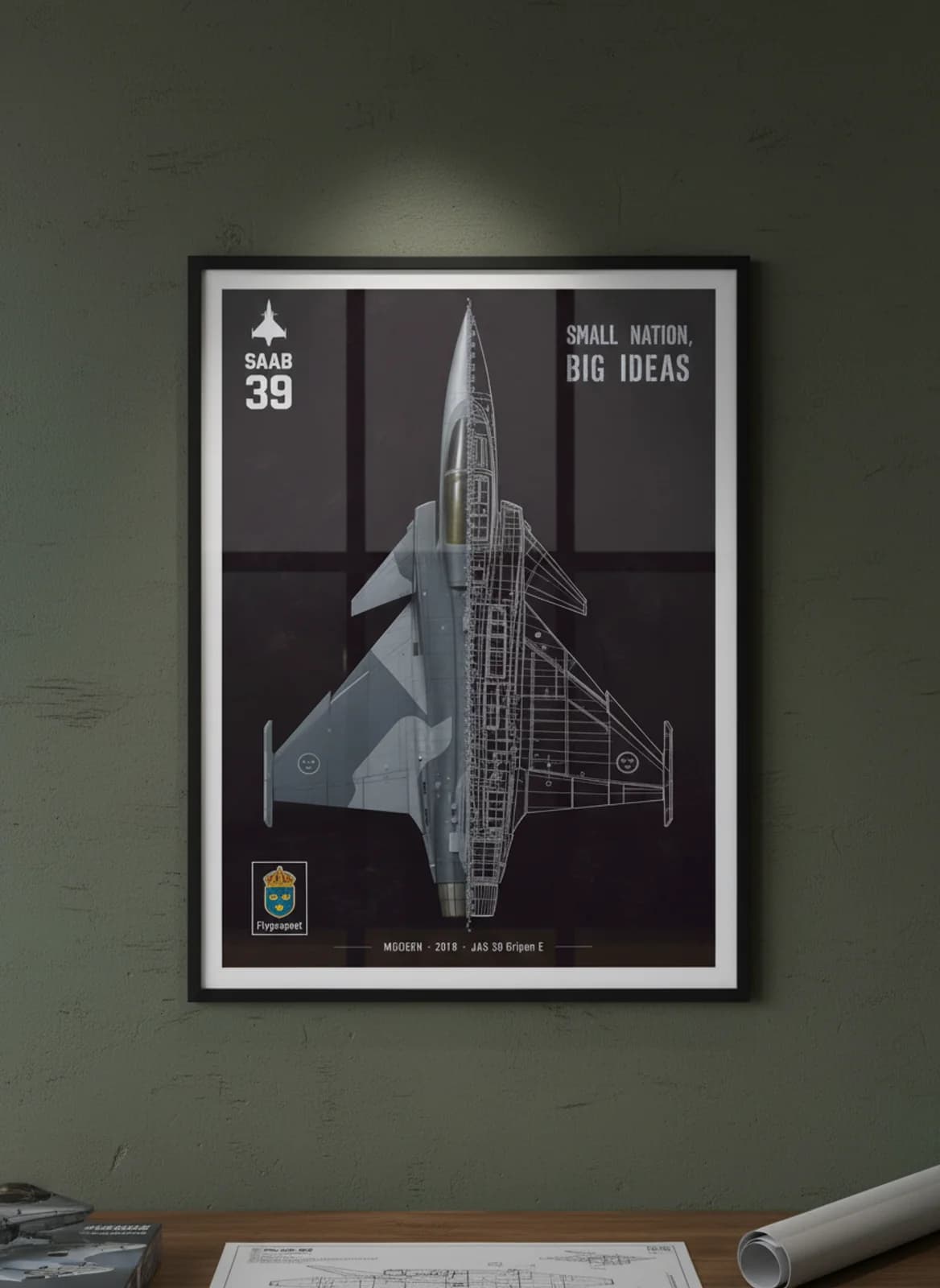 JAS 39 Gripen E — Aircraft Cutaway cutaway poster in black A2 frame on two-tone-grey-camouflage deep forest wall — Aircraft Cutaways enthusiast study mockup