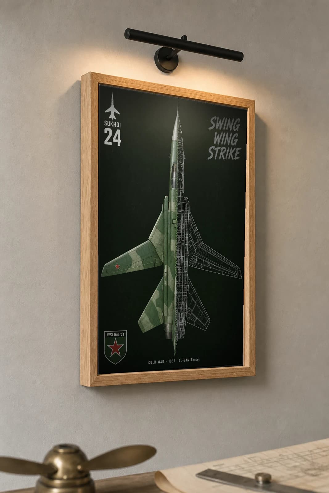 Su-24M Fencer Cutaway Poster — 1983 Swing-Wing Strike Bomber Split-View Blueprint Print — the framed print shown at a three-quarter angle on a styled gallery wall in a natural-oak frame