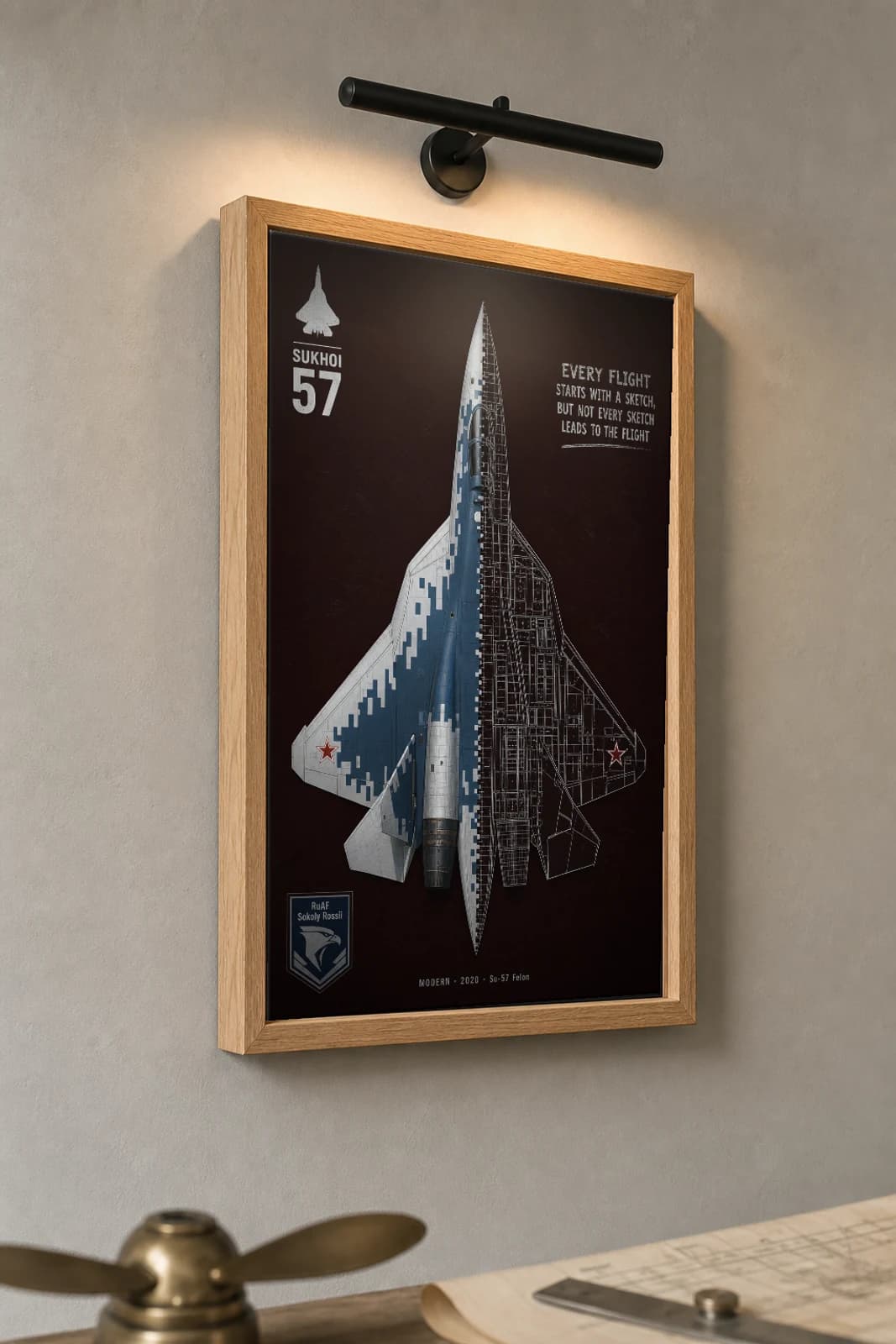 Su-57 Felon Cutaway Poster — Su-57 Modern Split-View Blueprint Print — the framed print shown at a three-quarter angle on a styled gallery wall in a natural-oak frame