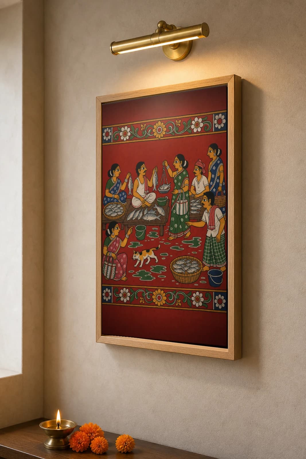 Chepala Market Cheriyal Fusion Print — A Morning Wet Fish Market with Hand-Scale, Baskets and a Cat, Nakashi Folk Grammar on a Vermilion Ground — the framed print shown at a three-quarter angle on a styled gallery wall in a natural-oak frame