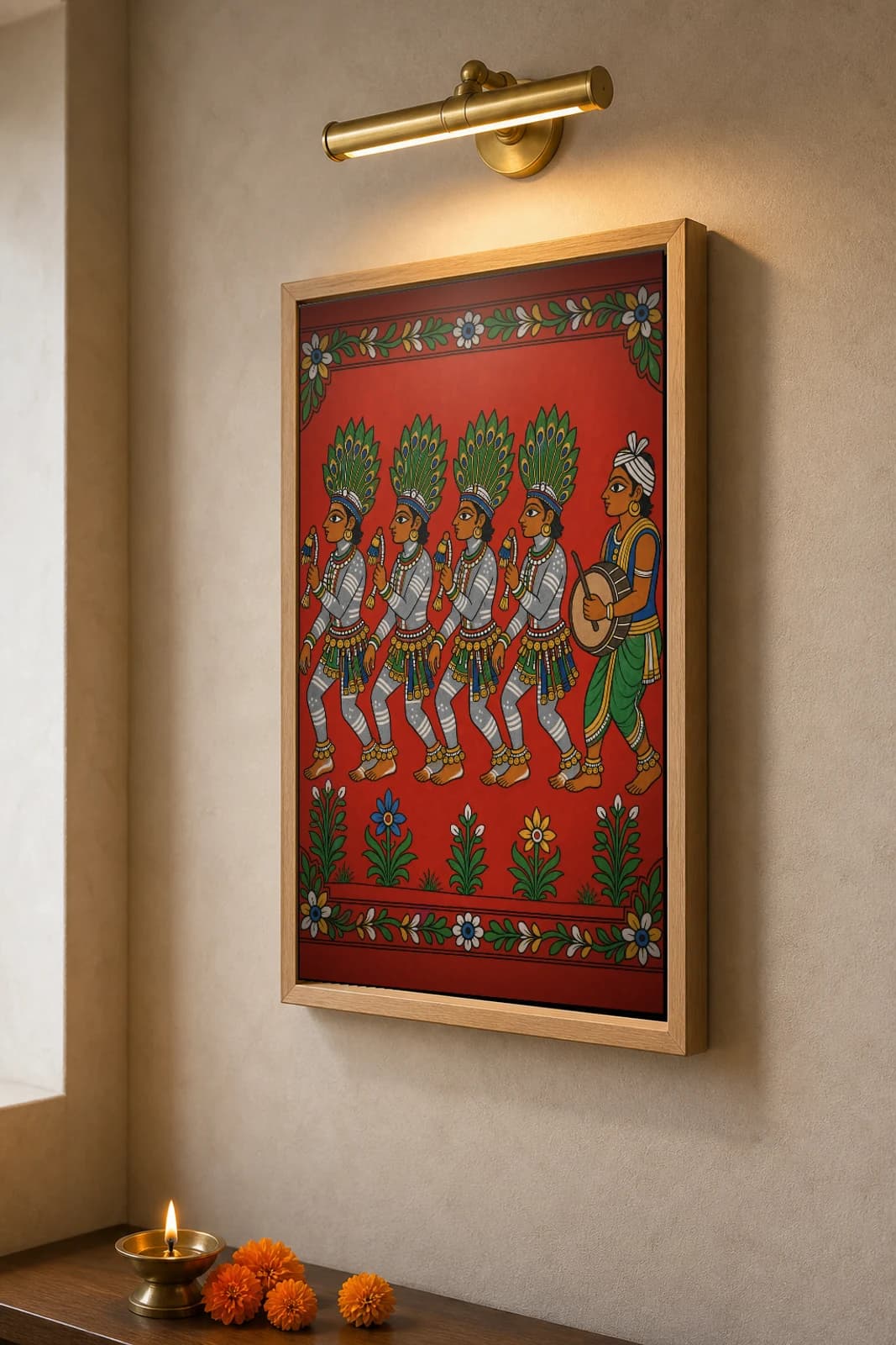 Gussadi Dancers Cheriyal Fusion Print — Raj Gond Dandari Dancers in Peacock-Feather Headdresses, Nakashi Folk Grammar on a Vermilion Ground — the framed print shown at a three-quarter angle on a styled gallery wall in a natural-oak frame