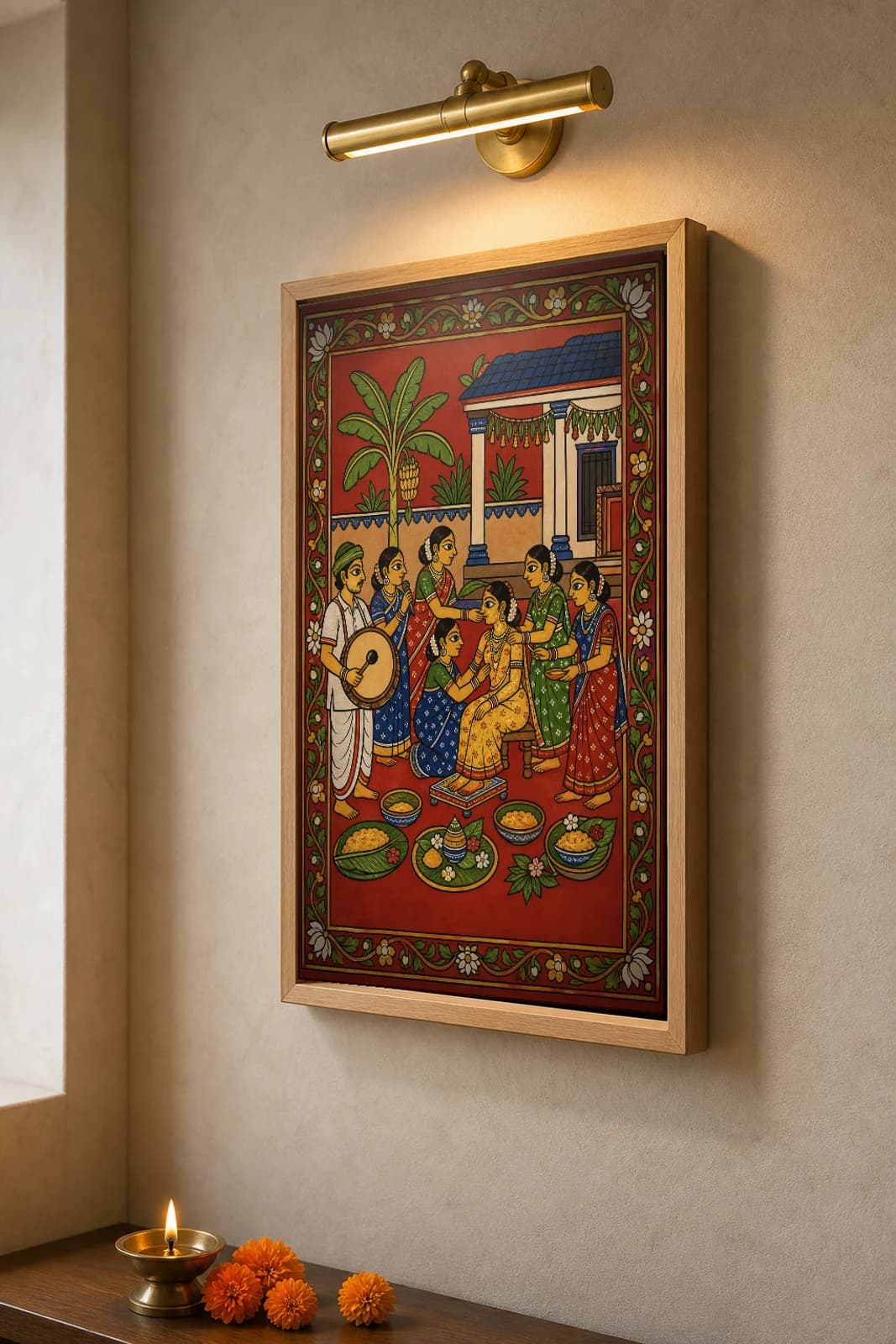 Haldi Veduka Cheriyal Fusion Print — A Pre-Wedding Turmeric Ceremony in a Courtyard, Nakashi Folk Grammar on a Vermilion Ground — the framed print shown at a three-quarter angle on a styled gallery wall in a natural-oak frame