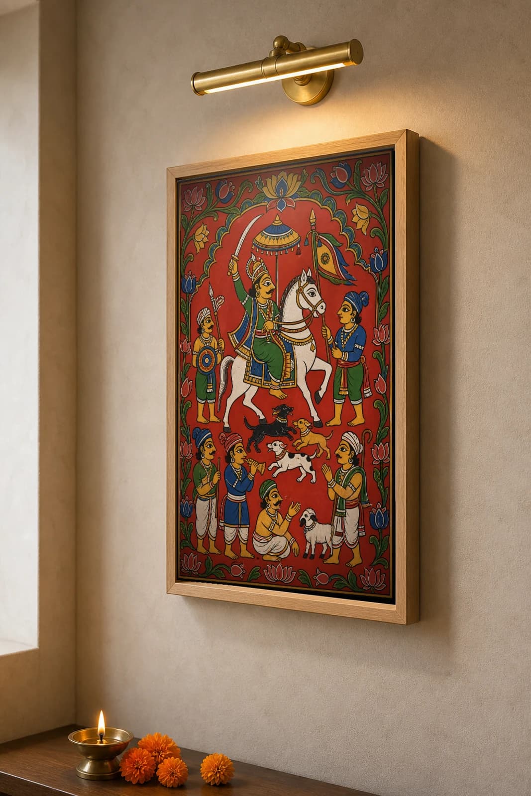 Mailara Deva Cheriyal Scroll Print — The Shepherd Folk-God on His White Horse, Nakashi Folk Grammar on a Vermilion Ground — the framed print shown at a three-quarter angle on a styled gallery wall in a natural-oak frame