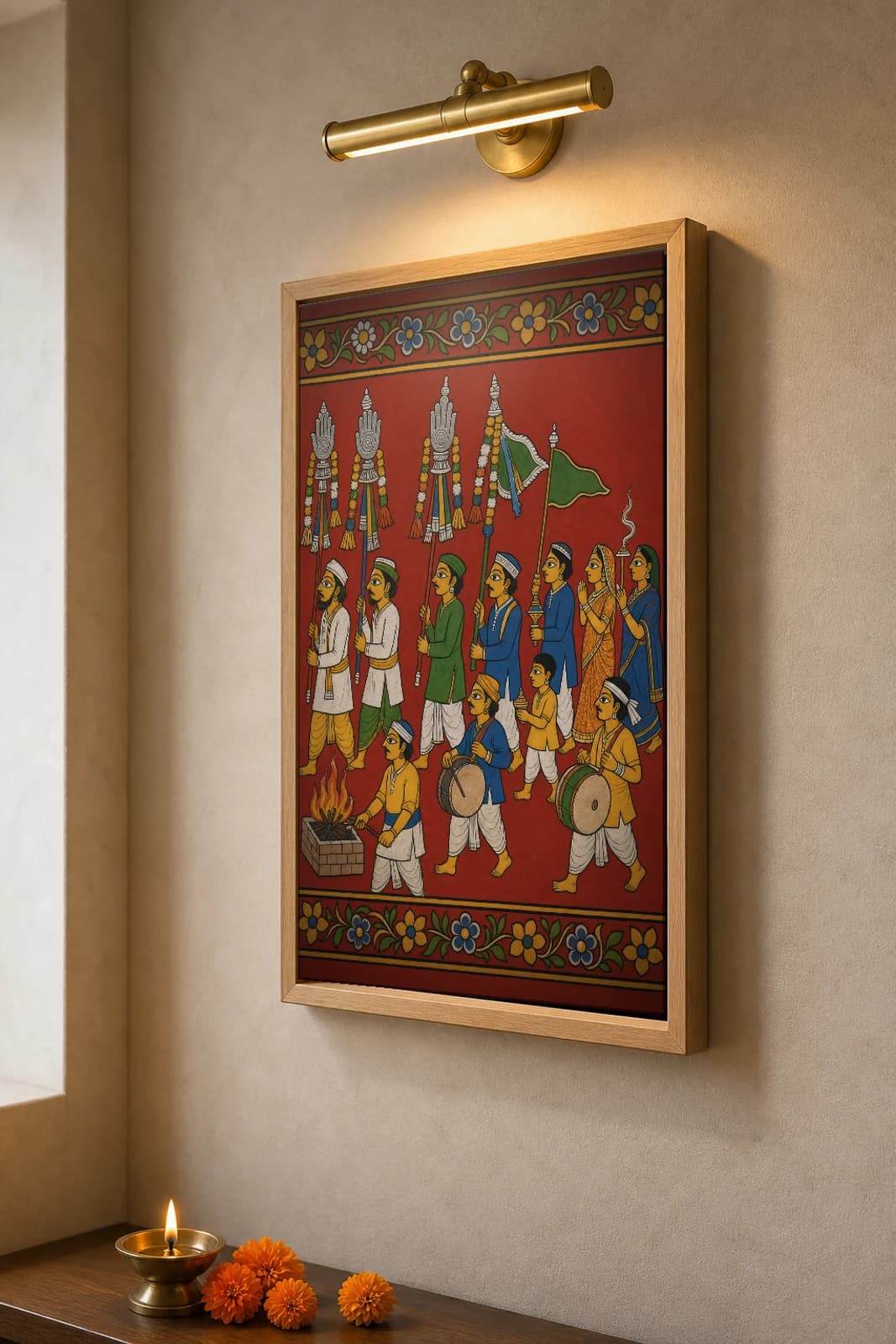 Peerla Panduga Cheriyal Print — the village Moharram procession of alams, drums and the fire-pit · collector edition on vermilion ground · Nakashi scroll grammar from Telangana — the framed print shown at a three-quarter angle on a styled gallery wall in a natural-oak frame