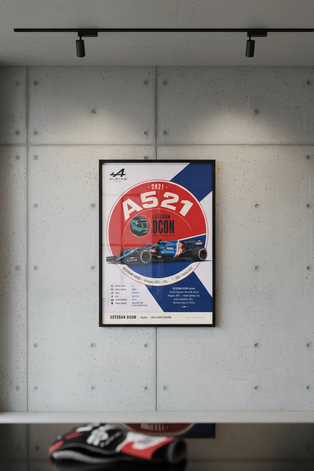 Esteban Ocon poster in black A2 frame on alpine-blue-white-red polished concrete wall — F1 heritage collector mockup