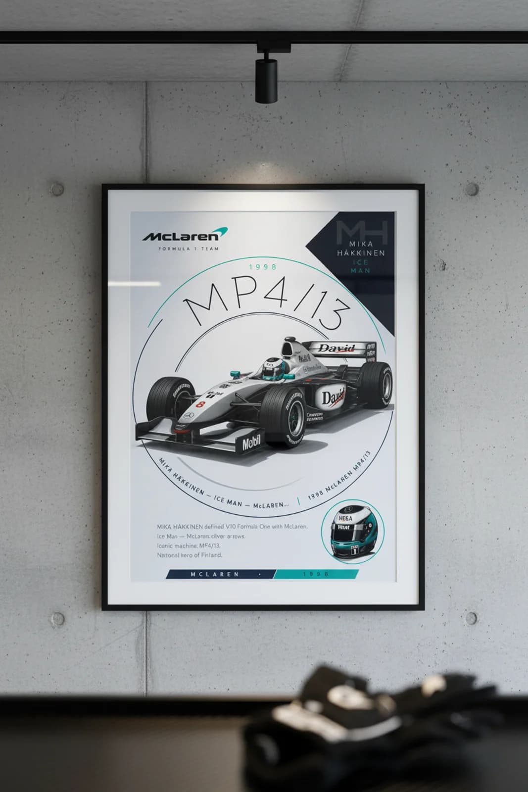 Mika Häkkinen poster in black A2 frame on mclaren-silver polished concrete wall — F1 heritage collector mockup