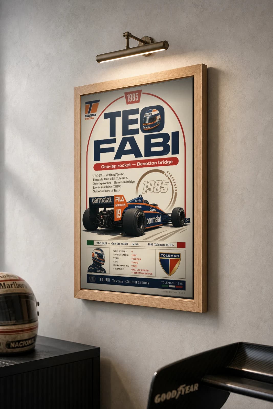 Teo Fabi Poster — 1985 Toleman TG185 Turbo F1 Heritage Collector Print — the framed print shown at a three-quarter angle on a styled gallery wall in a natural-oak frame