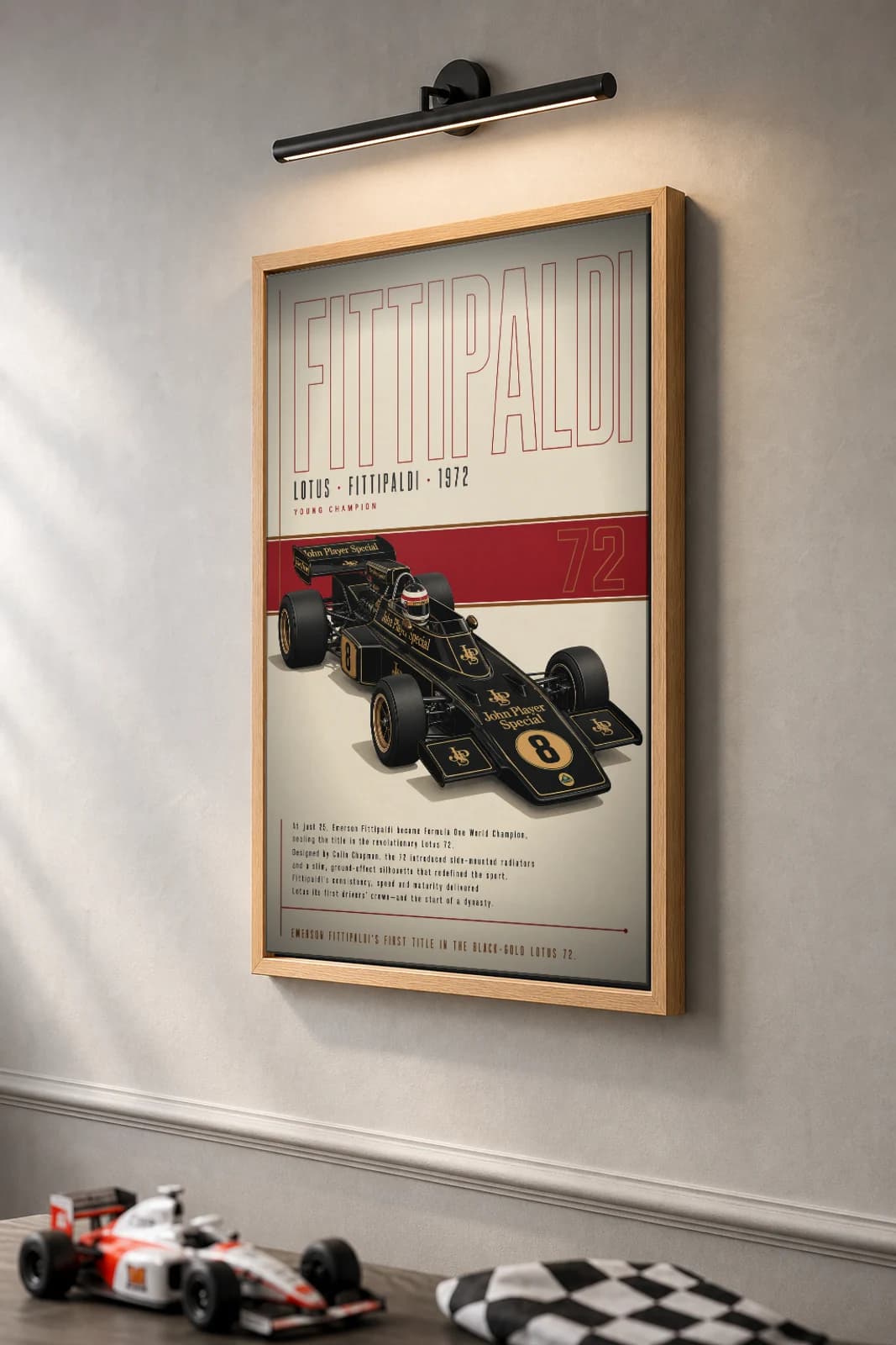 Emerson Fittipaldi — Emerson Fittipaldi — classic Lotus 72 heritage plate Poster — 72 F1 Grid Editorial Wall Art · framed A2 — the framed print shown at a three-quarter angle on a styled gallery wall in a natural-oak frame