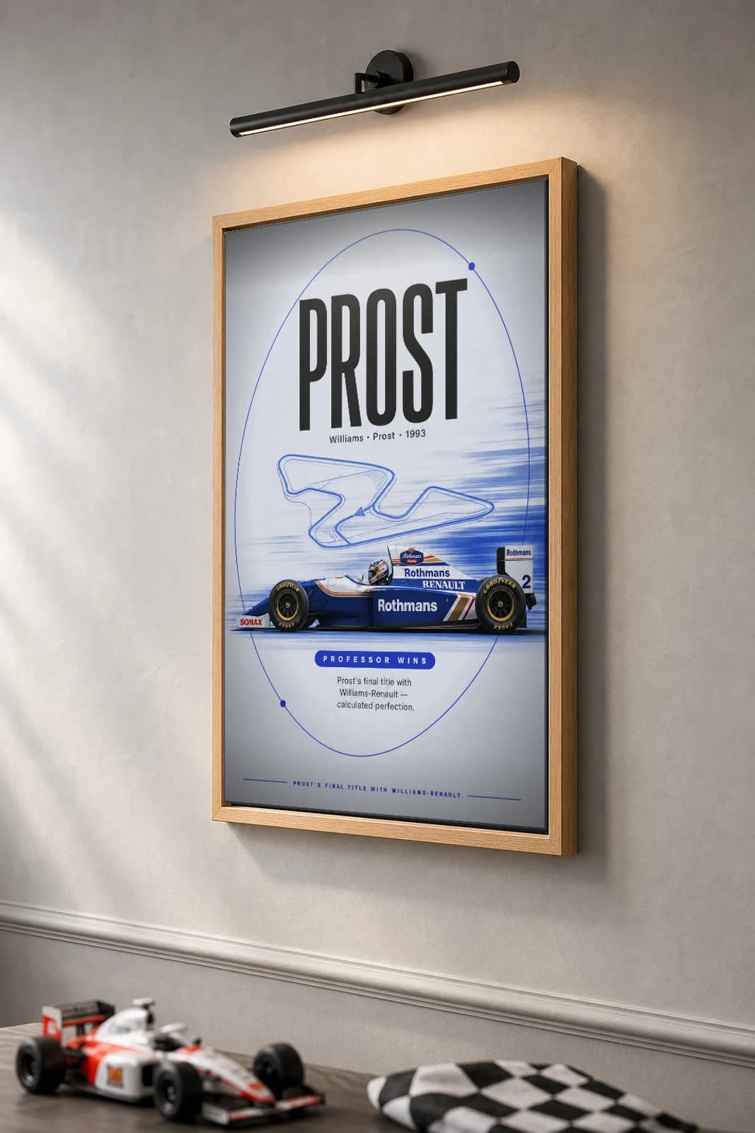 Alain Prost — Alain Prost — classic Williams Racing 93 heritage plate Poster — 93 F1 Grid Editorial Wall Art · framed A2 — the framed print shown at a three-quarter angle on a styled gallery wall in a natural-oak frame