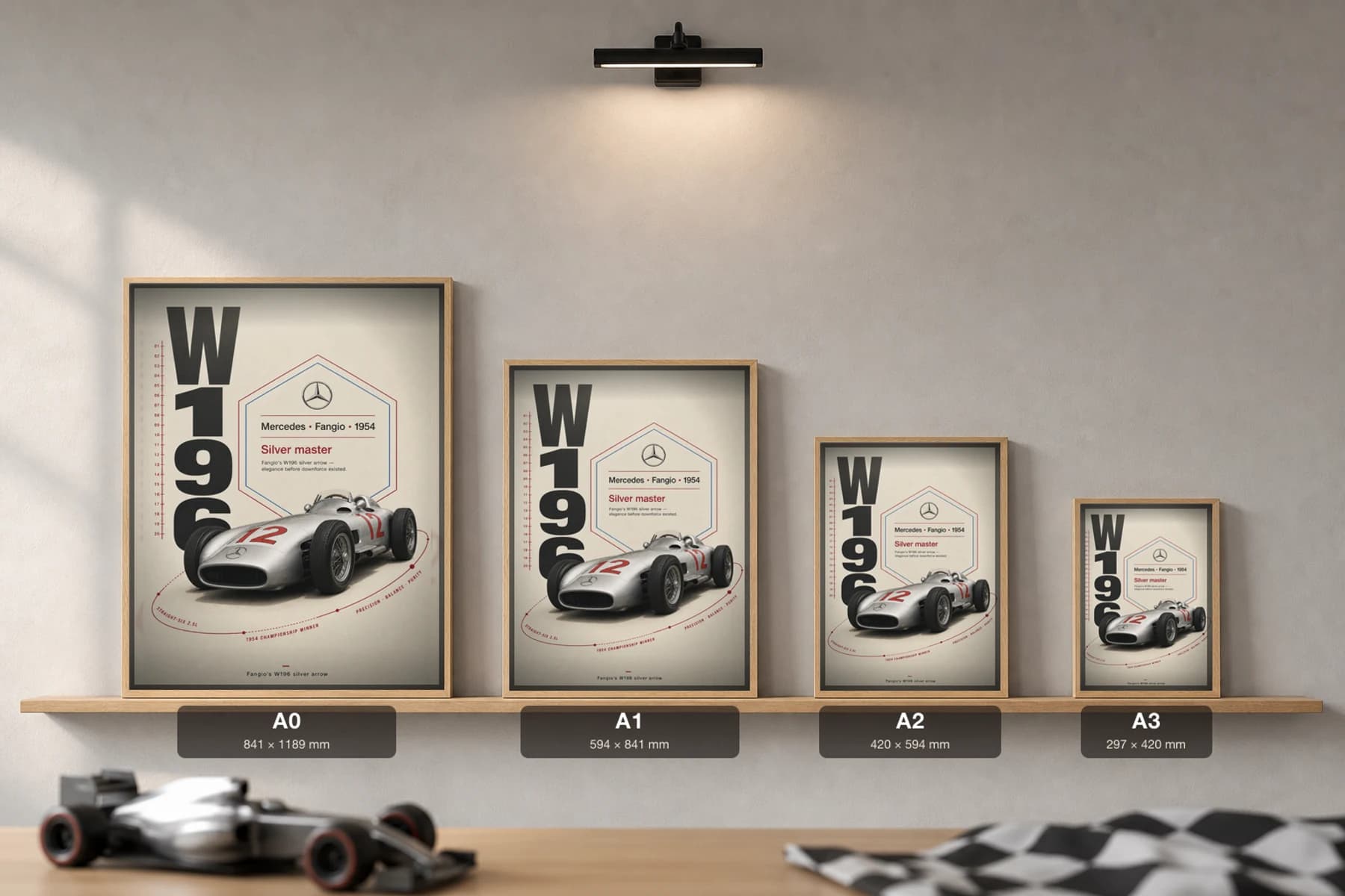 Juan Manuel Fangio — Silver Arrow W196 mastery Poster — 1954 F1 Grid Editorial Wall Art · framed A2 — print size guide showing the artwork at A0, A1, A2 and A3 in natural-oak frames at true relative scale
