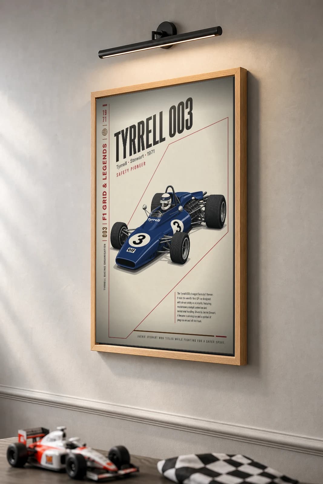 Jackie Stewart — Tyrrell 003 safety era Poster — 1971 F1 Grid Editorial Wall Art · framed A2 — the framed print shown at a three-quarter angle on a styled gallery wall in a natural-oak frame