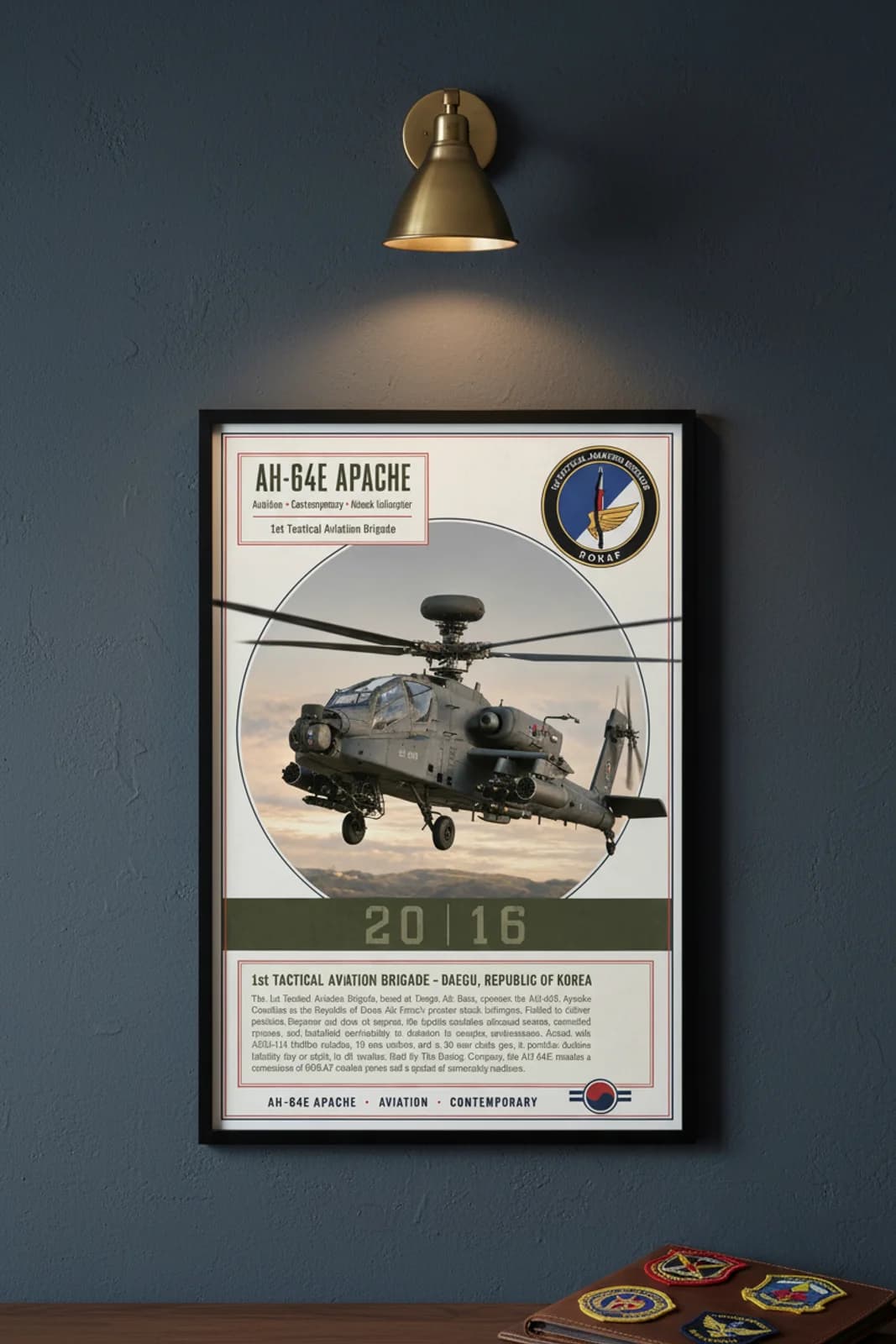 AH-64E Apache aviation poster in black A2 frame on rok-red navy hangar wall — Aviation Heroes mockup