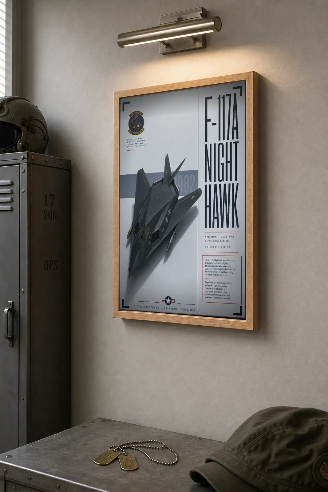F-117 Nighthawk Poster — 49th FW / 9th FS military aviation wall art · framed A2 · 1982 — the framed print shown at a three-quarter angle on a styled gallery wall in a natural-oak frame