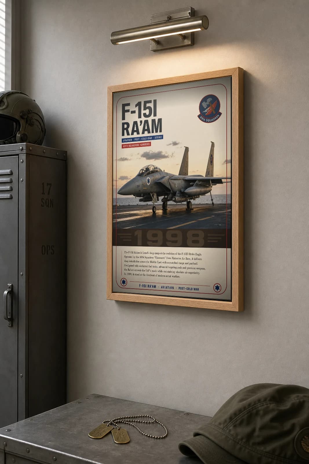 F-15I Ra'am Poster — 69th Squadron Hammers military aviation wall art · framed A2 · 1998 — the framed print shown at a three-quarter angle on a styled gallery wall in a natural-oak frame