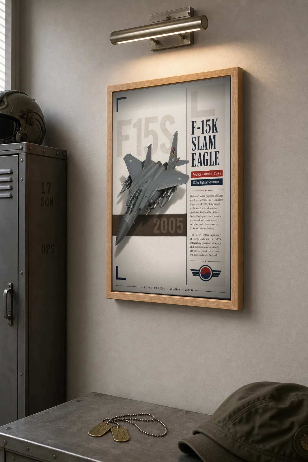 F-15K Slam Eagle Poster — 122nd Fighter Squadron military aviation wall art · framed A2 · 2005 — the framed print shown at a three-quarter angle on a styled gallery wall in a natural-oak frame