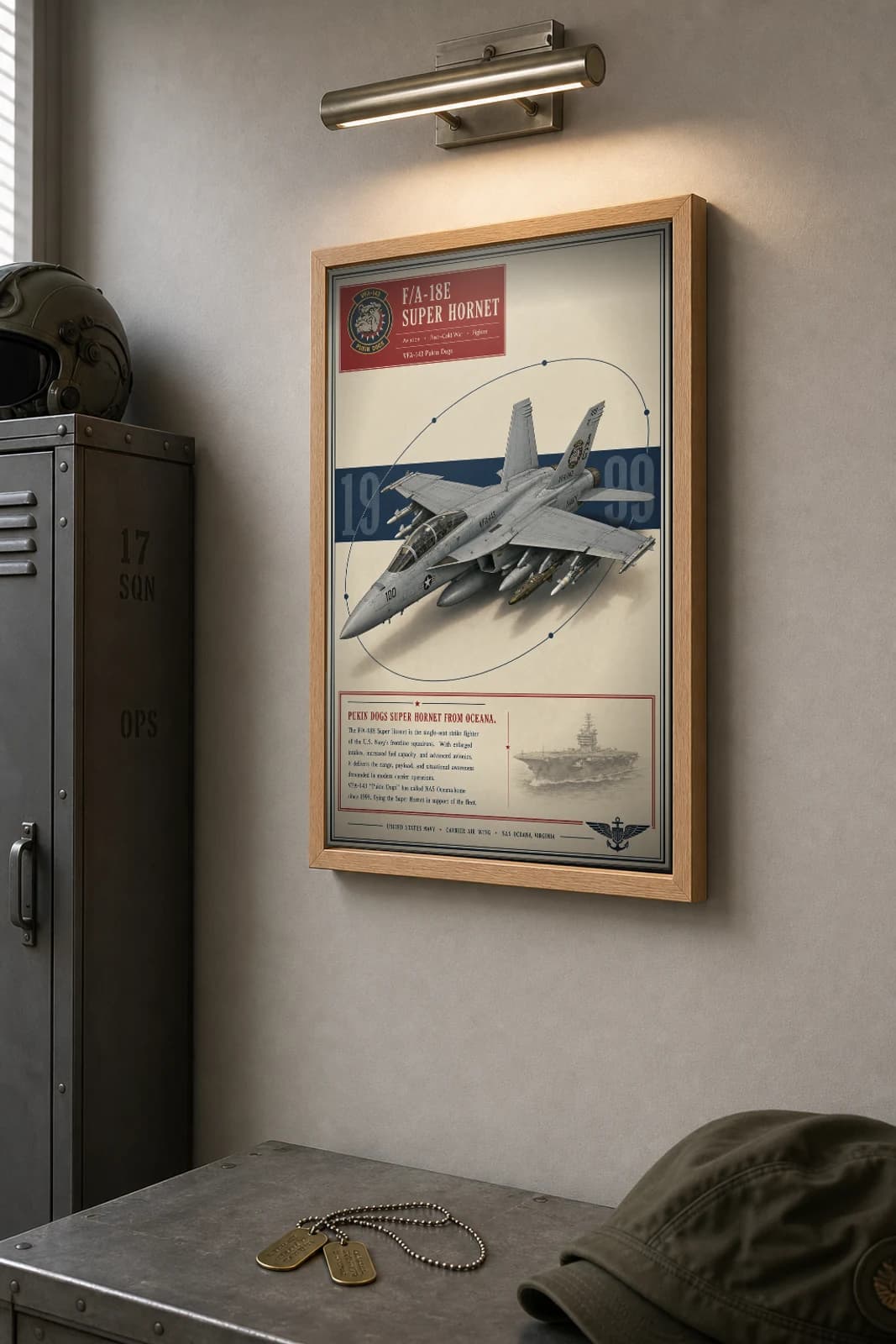 F/A-18E Super Hornet Poster — VFA-143 Pukin Dogs military aviation wall art · framed A2 · 1999 — the framed print shown at a three-quarter angle on a styled gallery wall in a natural-oak frame