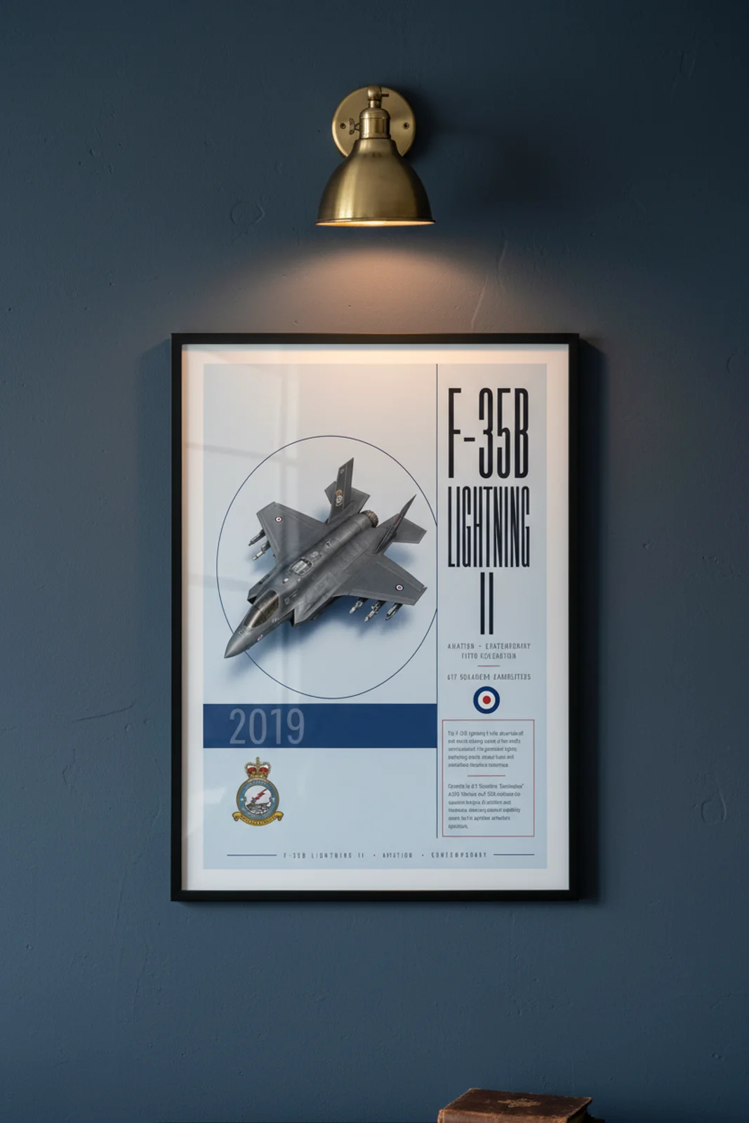 F-35B RAF 617 Sqn aviation poster in black A2 frame on light-blue-grey navy hangar wall — Aviation Heroes mockup