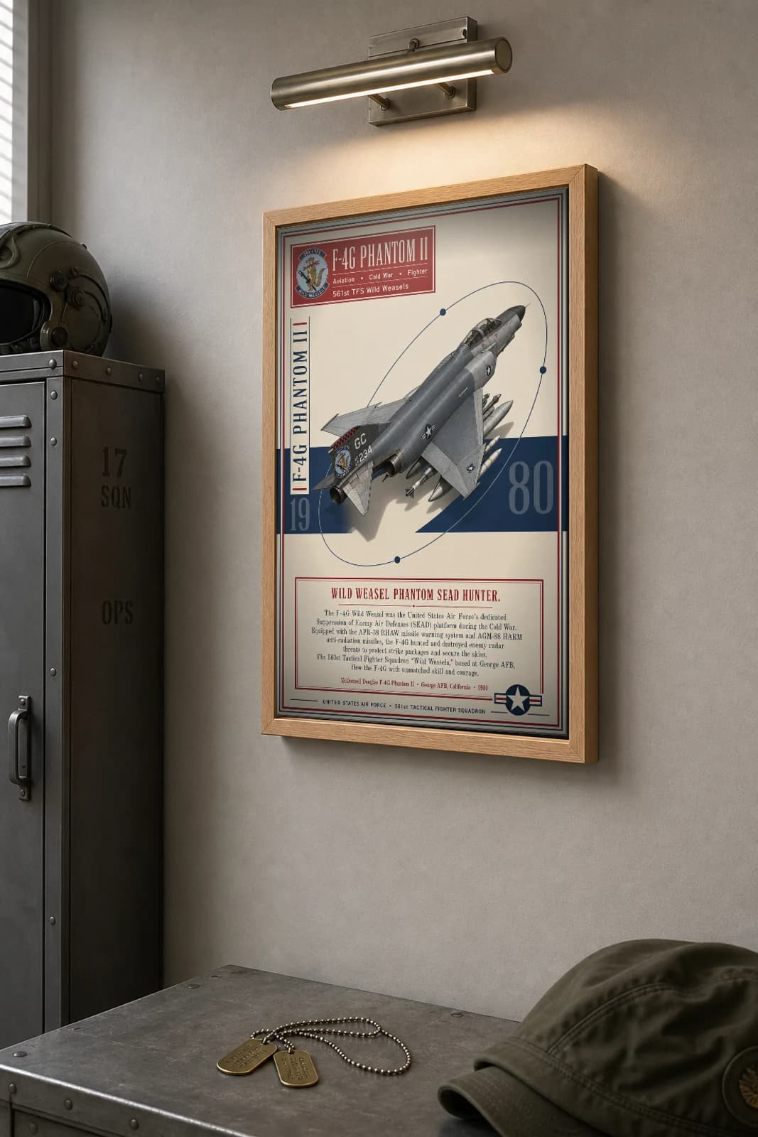 F-4G Phantom II Wild Weasel Poster — 561st TFS Wild Weasels military aviation wall art · framed A2 · 1980 — the framed print shown at a three-quarter angle on a styled gallery wall in a natural-oak frame