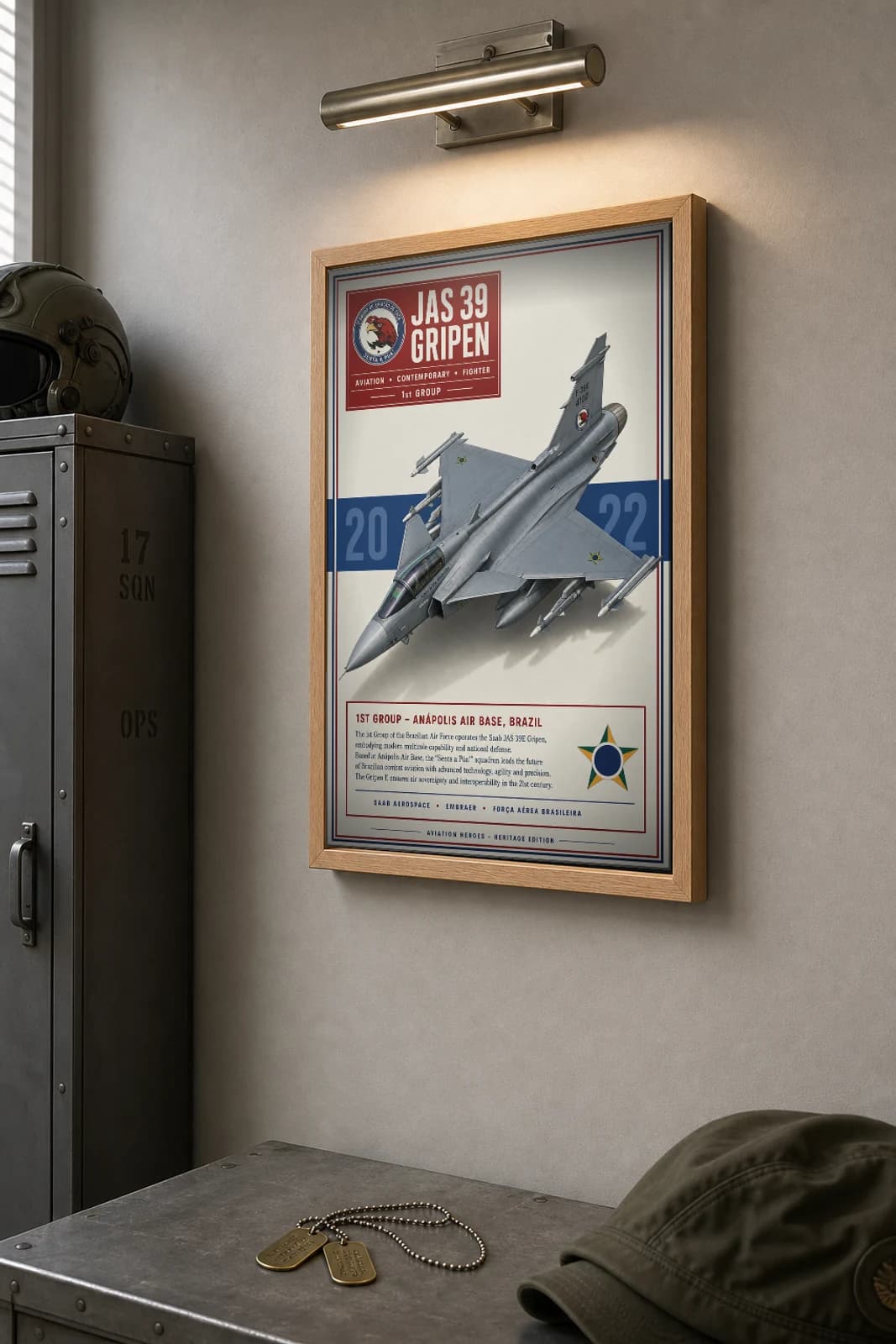 JAS 39 Gripen E Poster — 1st Group military aviation wall art · framed A2 · 2022 — the framed print shown at a three-quarter angle on a styled gallery wall in a natural-oak frame