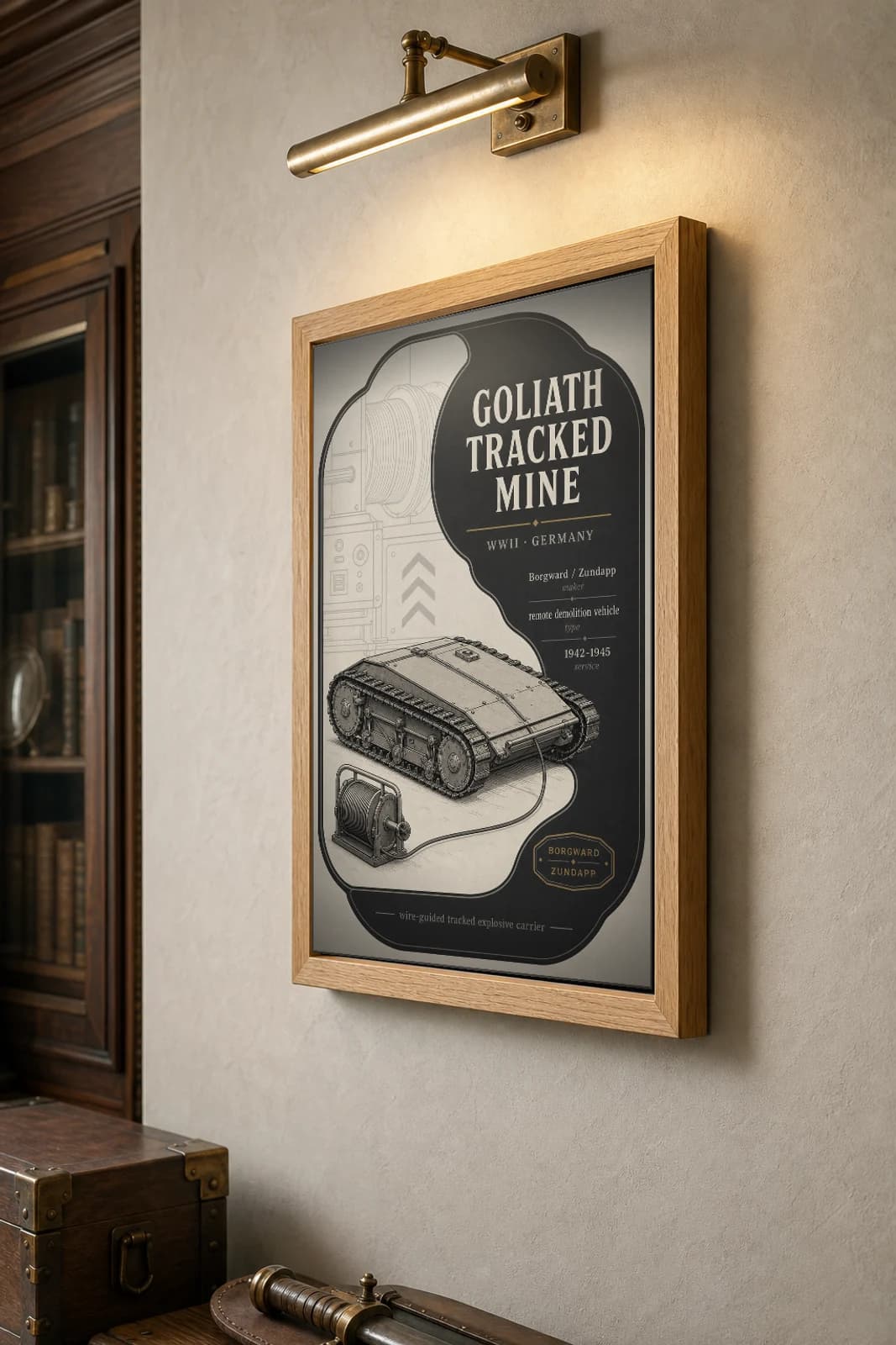 Goliath Tracked Mine Poster — WWII Armoury Specimen Print · framed A2 — the framed print shown at a three-quarter angle on a styled gallery wall in a natural-oak frame