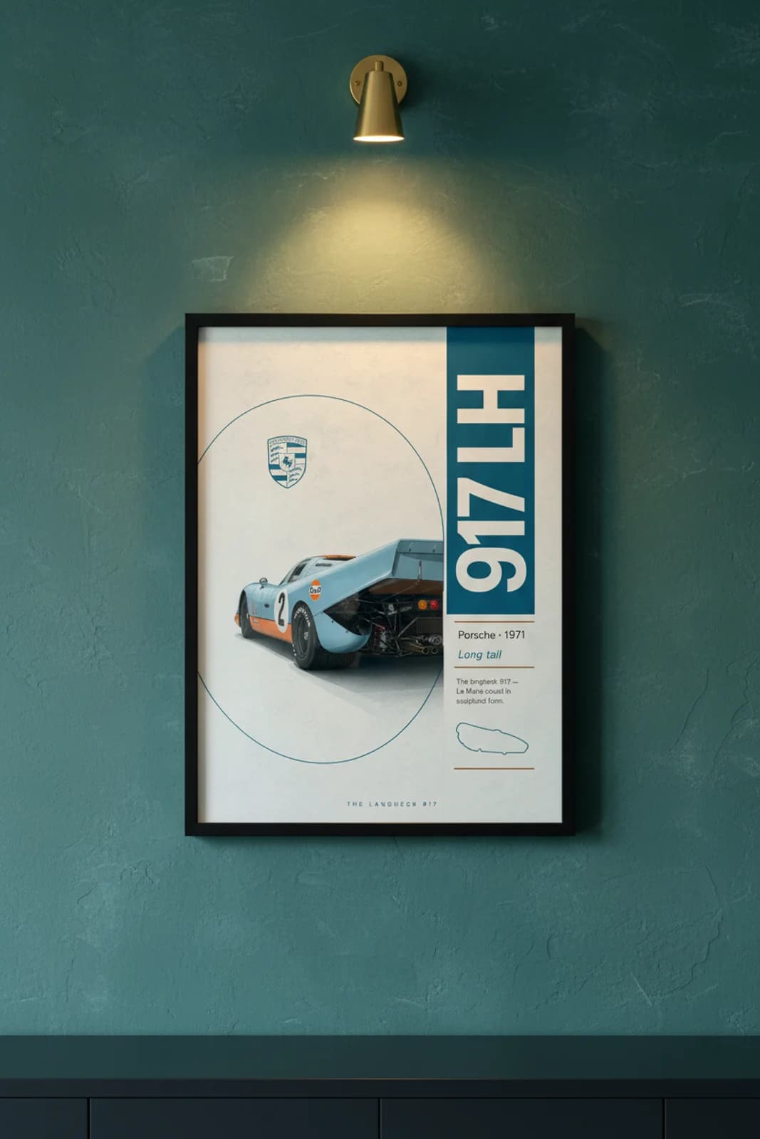Porsche 917 Langheck poster in black A2 frame on dark-teal-banner lime-wash wall — Heritage Icons collector lounge mockup