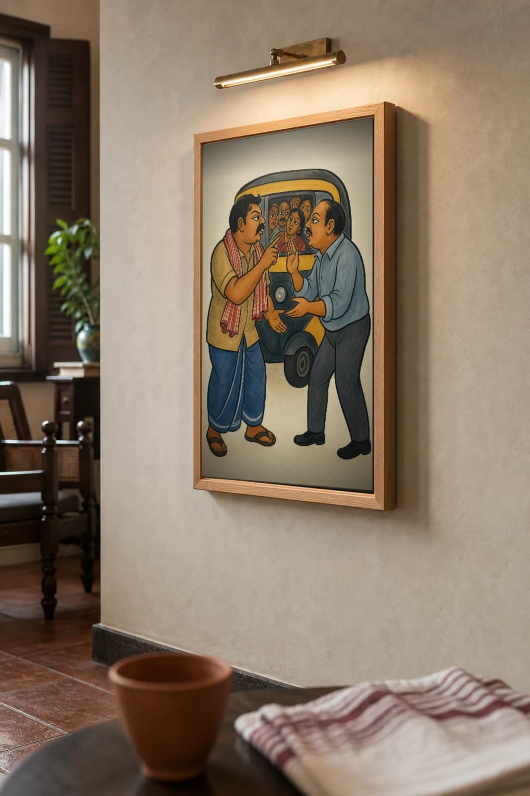 The Auto-Wallah Kalighat Print — the autorickshaw driver and a passenger haggling over the fare at a crowded stand, contemporary Bengal patua satire, hand-numbered collector edition — the framed print shown at a three-quarter angle on a styled gallery wall in a natural-oak frame