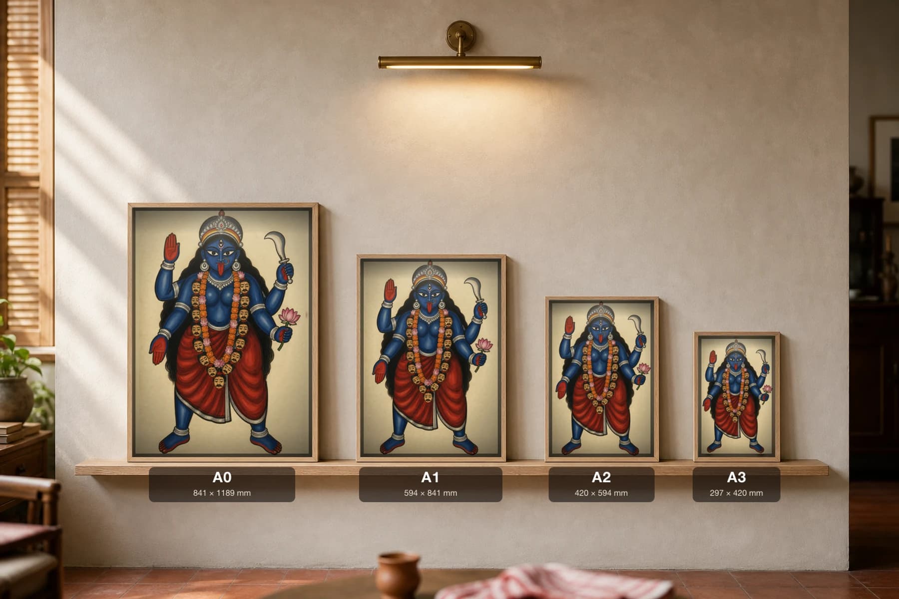 Maa Kali Kalighat Print — the blue goddess in dakshina stance with khadga, lotus and a garland of heads, the namesake deity of Kalighat, devotional Bengal patua brush, hand-numbered collector edition — print size guide showing the artwork at A0, A1, A2 and A3 in natural-oak frames at true relative scale