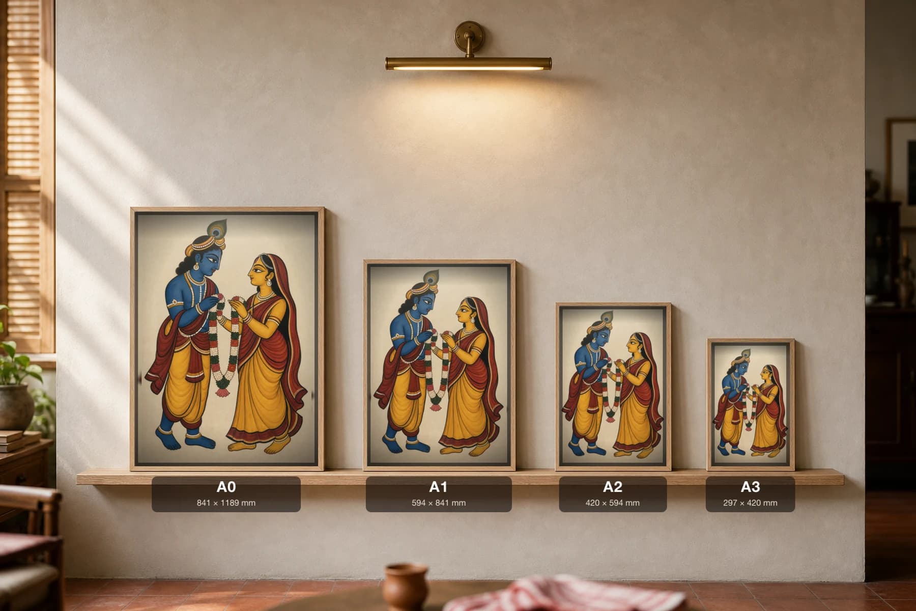 Radha Krishna — Kalighat-style devotional art print of the divine pair exchanging a garland, Bengal patua brush · collector edition · framed A2 — print size guide showing the artwork at A0, A1, A2 and A3 in natural-oak frames at true relative scale