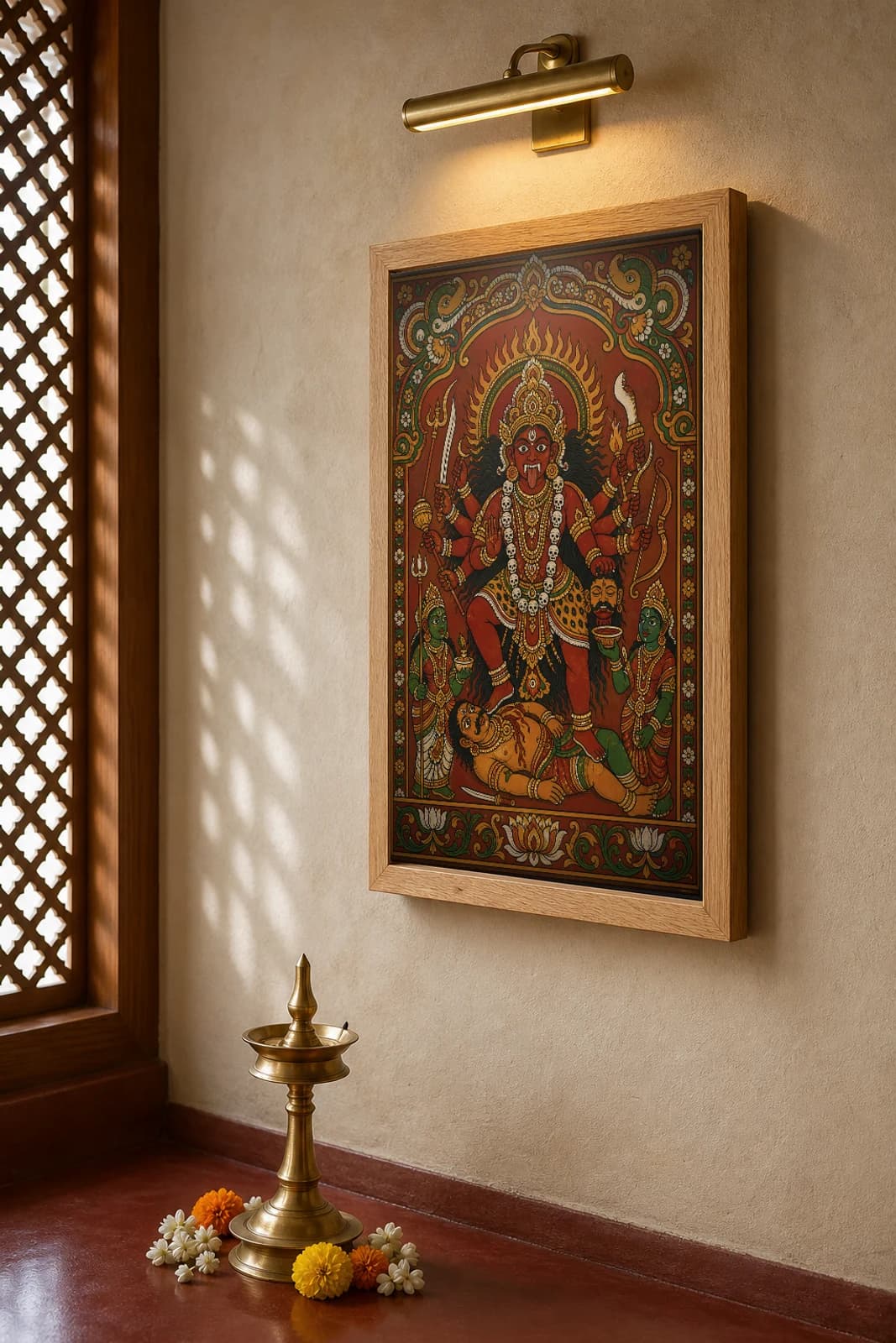 Bhadrakali Kerala Mural Art Print — fierce red goddess slaying Darika in flat panchavarna bhitti-chitra style, collector edition of 500 — the framed print shown at a three-quarter angle on a styled gallery wall in a natural-oak frame