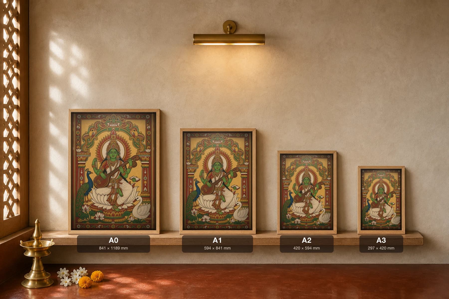 Saraswati with Veena Kerala Mural Art Print — the goddess of learning on a lotus with veena, peacock and swan in panchavarna bhitti-chitra style · collector edition A2 — print size guide showing the artwork at A0, A1, A2 and A3 in natural-oak frames at true relative scale