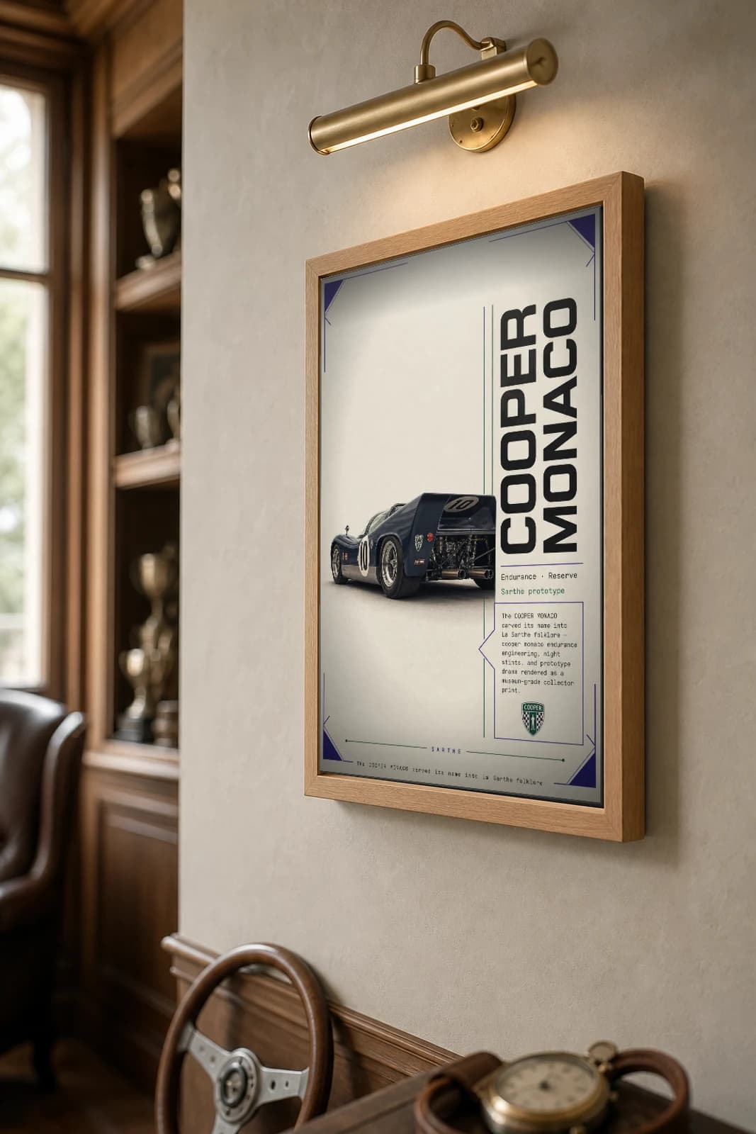Cooper Monaco Poster — 1960 24 Hours of Le Mans Endurance Racing Wall Art · framed A2 — the framed print shown at a three-quarter angle on a styled gallery wall in a natural-oak frame
