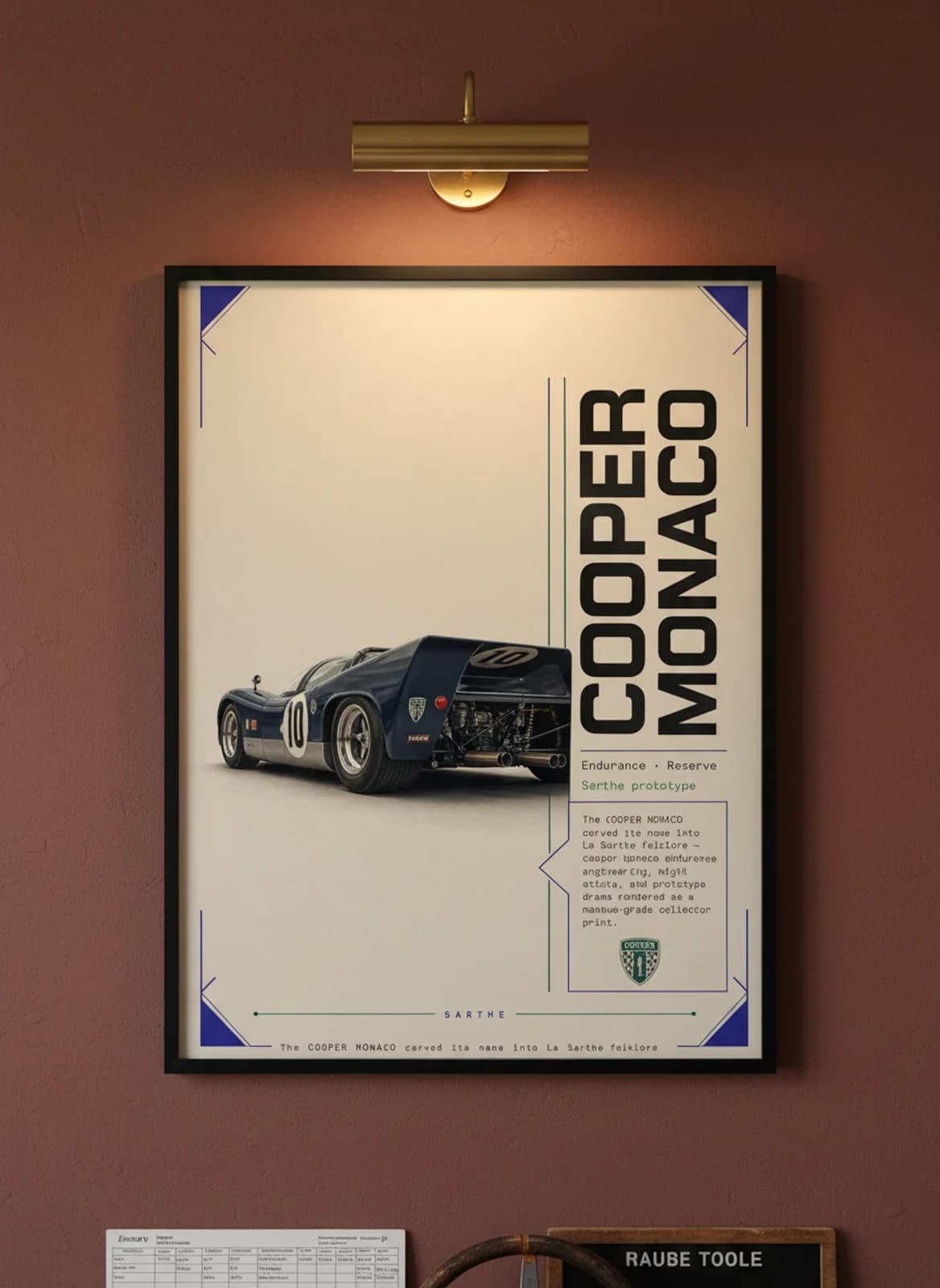 Cooper Monaco Le Mans endurance print in black A2 frame on warm-cream-parchment oxblood wall — Le Mans mockup