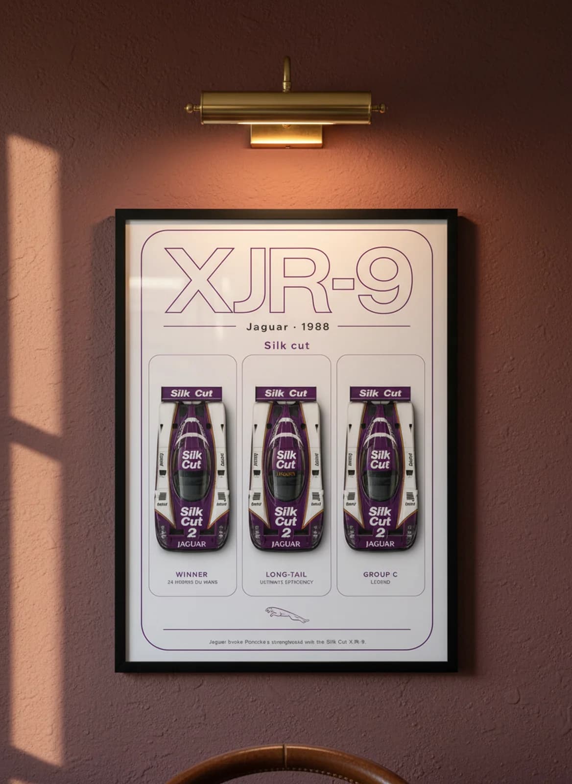 XJR-9 Silk Cut Le Mans endurance print in black A2 frame on warm-white-parchment oxblood wall — Le Mans mockup
