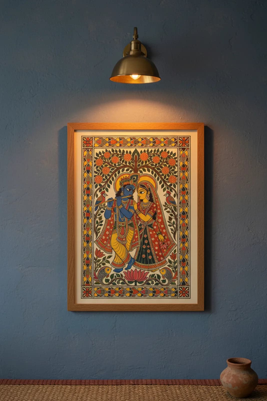 Radha Krishna Garden Madhubani print in natural_oak A2 frame on cobalt-blue terracotta limewash wall — Mithila folk art mockup