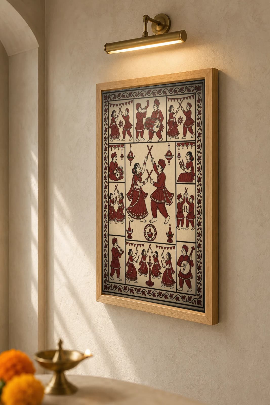 Dandiya Raas — Mata ni Pachedi-style art print · paired stick-dancers striking dandiya overhead, told in shrine-cloth grammar · madder-red, iron-black, warm ecru cotton · collector edition — the framed print shown at a three-quarter angle on a styled gallery wall in a natural-oak frame